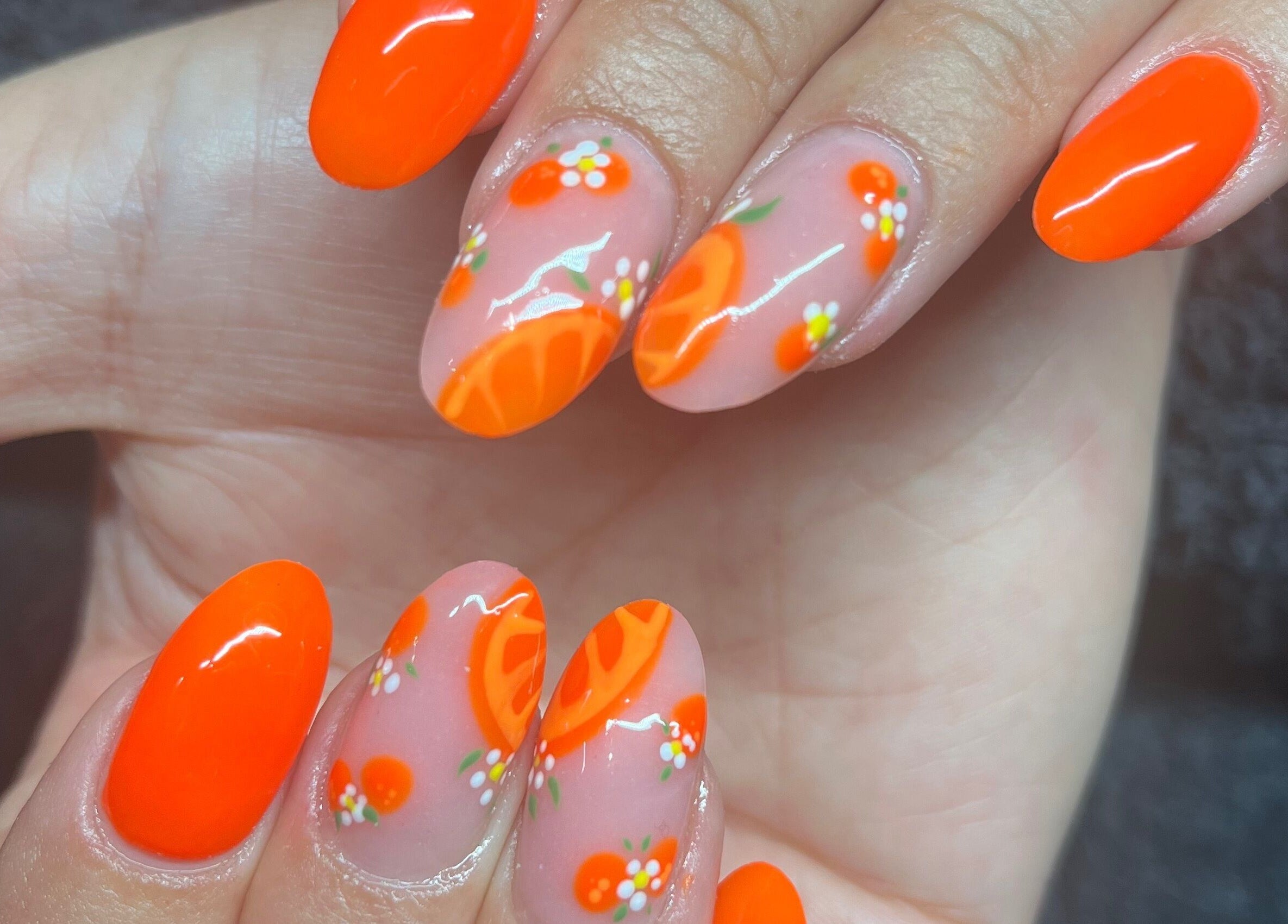 Vibrant citrus nail art at Needham Gym, Ipswich, England, GB showcases intricate design and creativity.