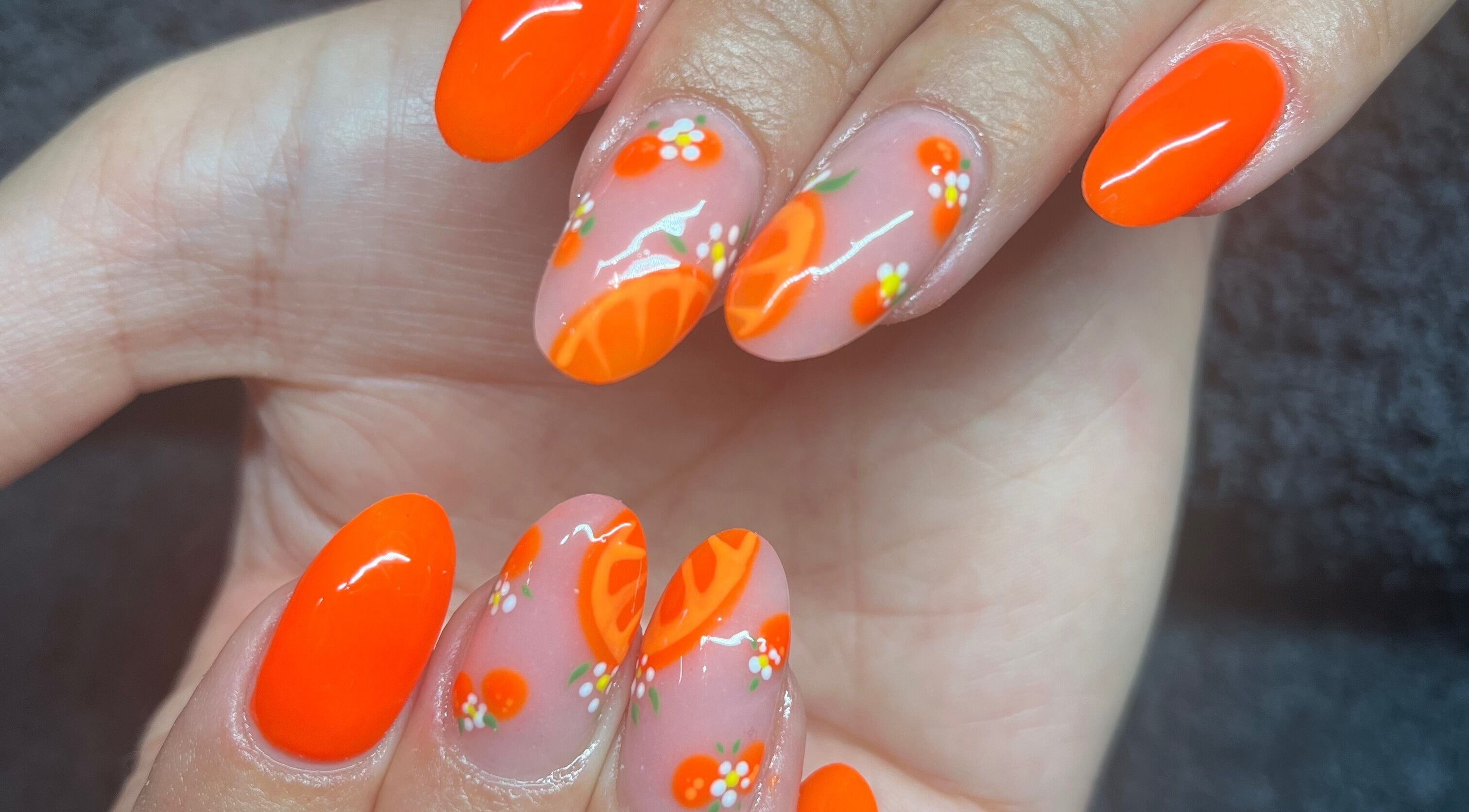 Vibrant citrus nail art at Needham Gym, Ipswich, England, GB showcases intricate design and creativity.