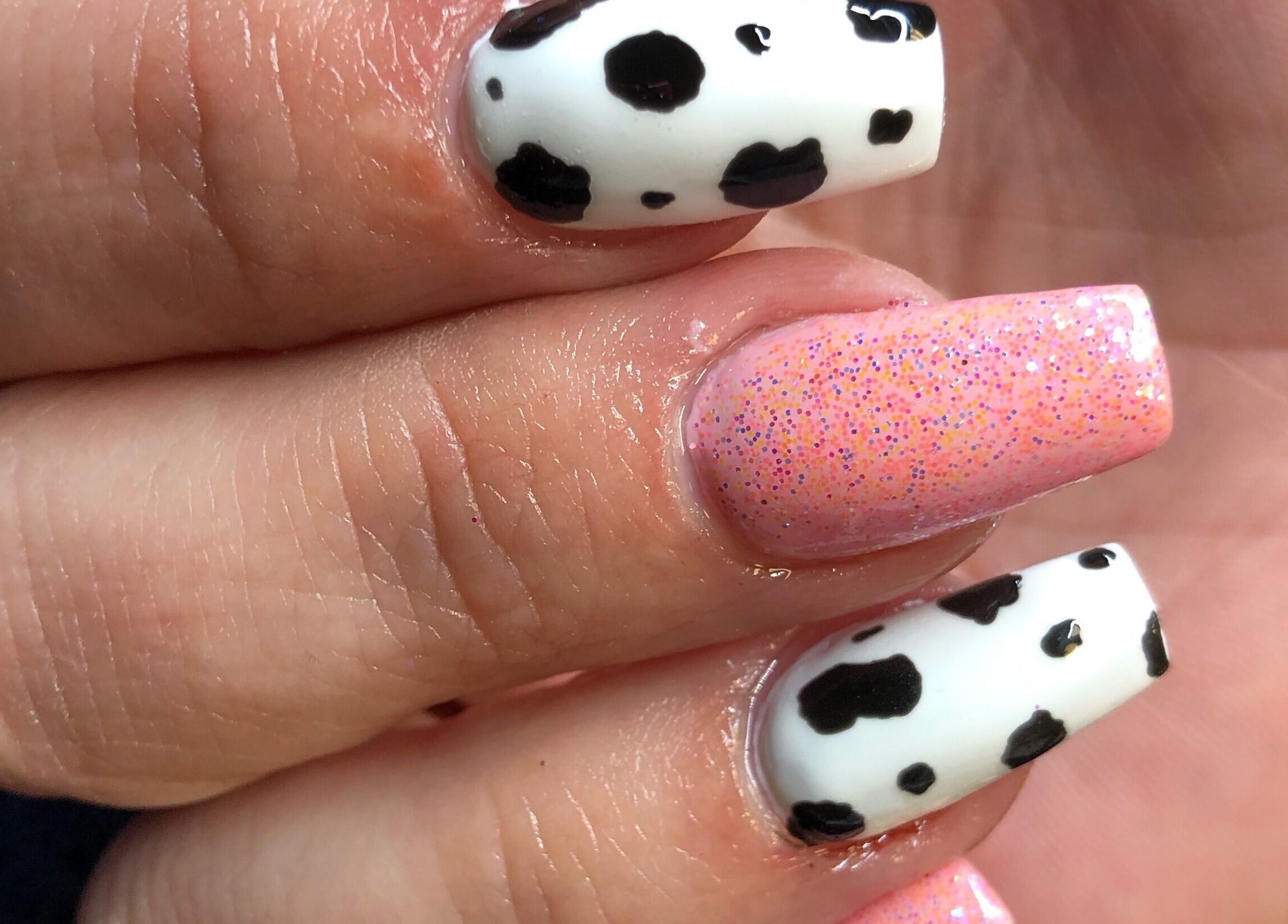 Chic cow-print and pink glitter nails at Needham Gym, Ipswich, England, GB. Perfect for stylish transformations.