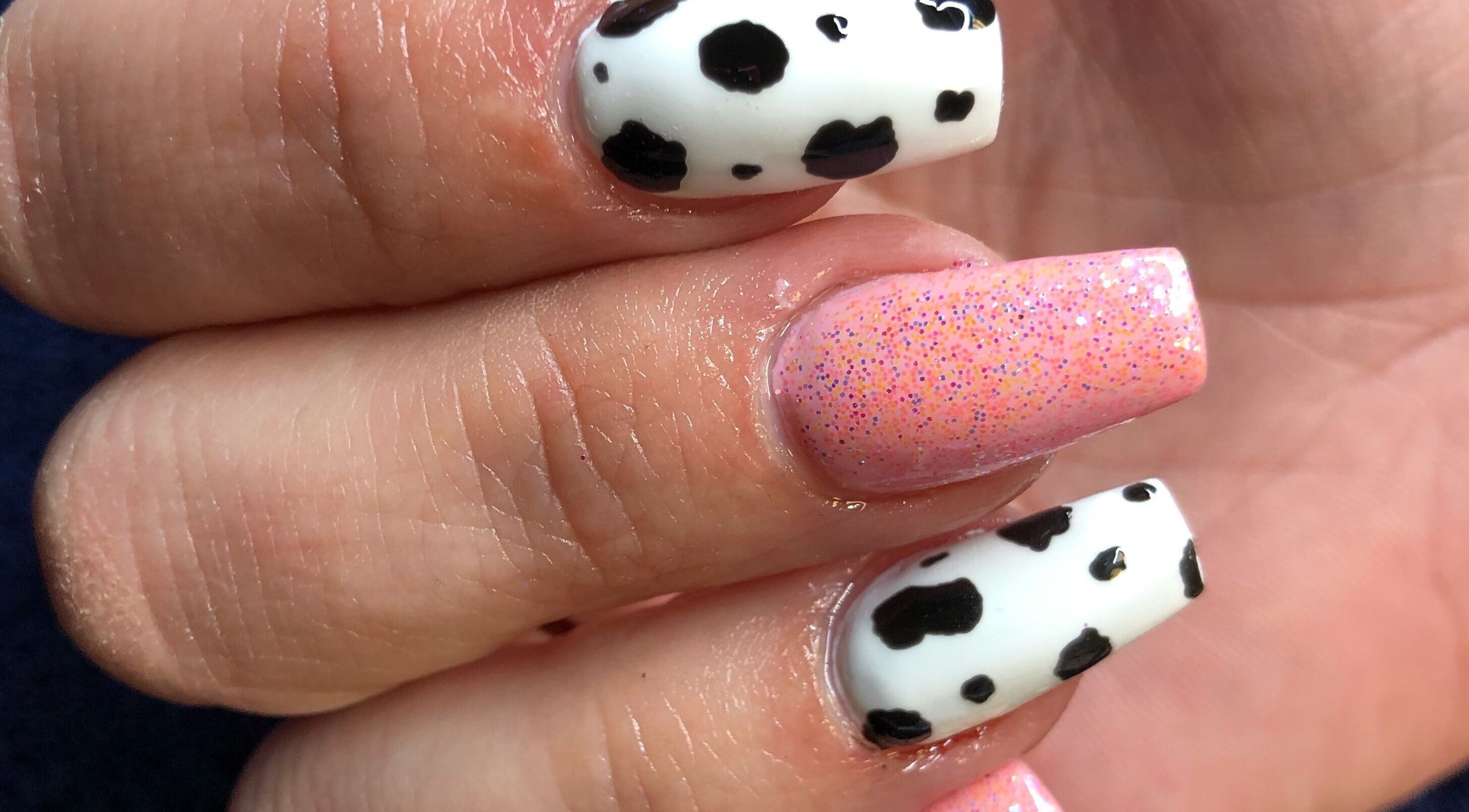 Chic cow-print and pink glitter nails at Needham Gym, Ipswich, England, GB. Perfect for stylish transformations.