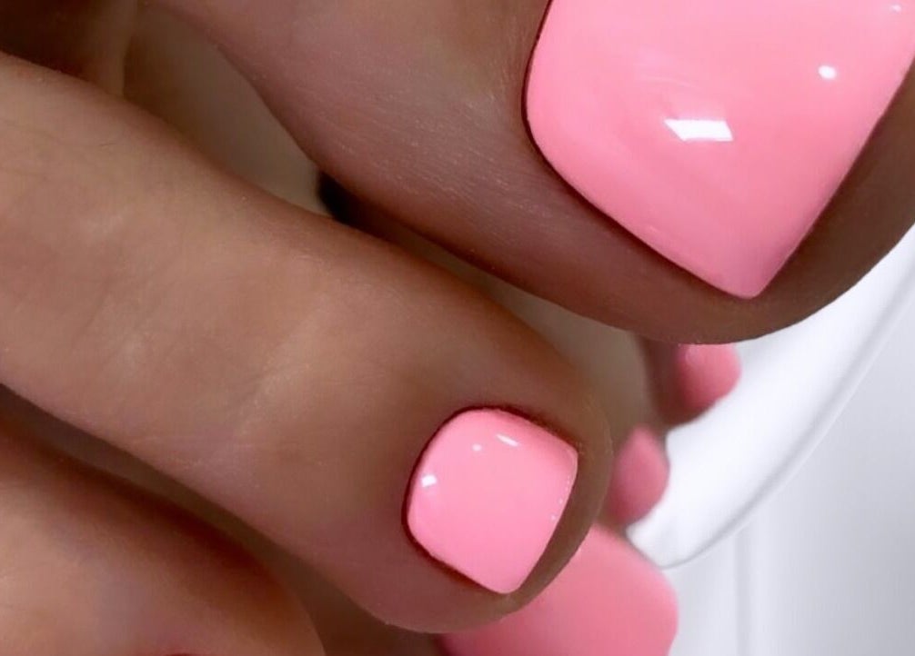 Vibrant pink pedicure at Nail Art Studio, Gainsborough, England, GB showcasing expert nail craftsmanship.