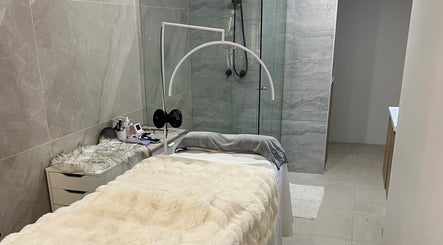 Serene spa room at QueenSt. Beauty Lounge, Perth, Western Australia, AU with plush bedding and elegant decor.