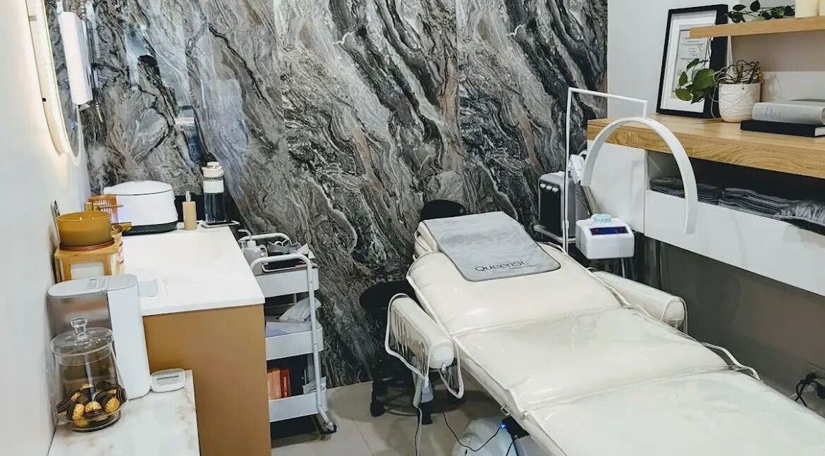 Modern treatment room at QueenSt. Beauty Lounge, Perth City, WA, featuring elegant decor and luxurious spa bed.