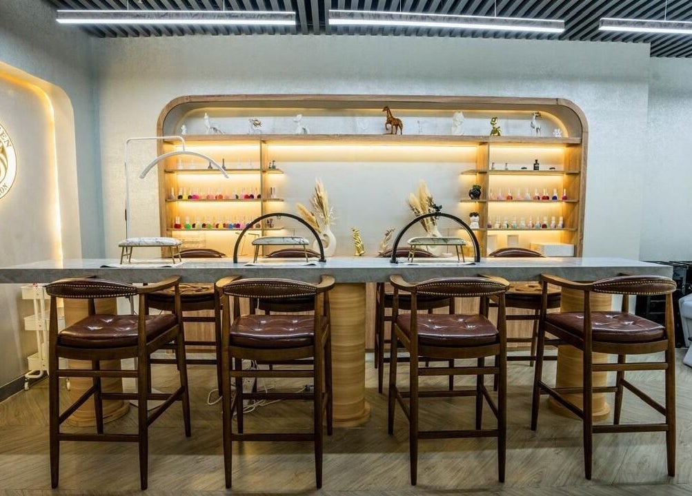 Elegant interior of Peaky Queen Beauty Salon, Dubai, AE showcasing manicure station and decor.