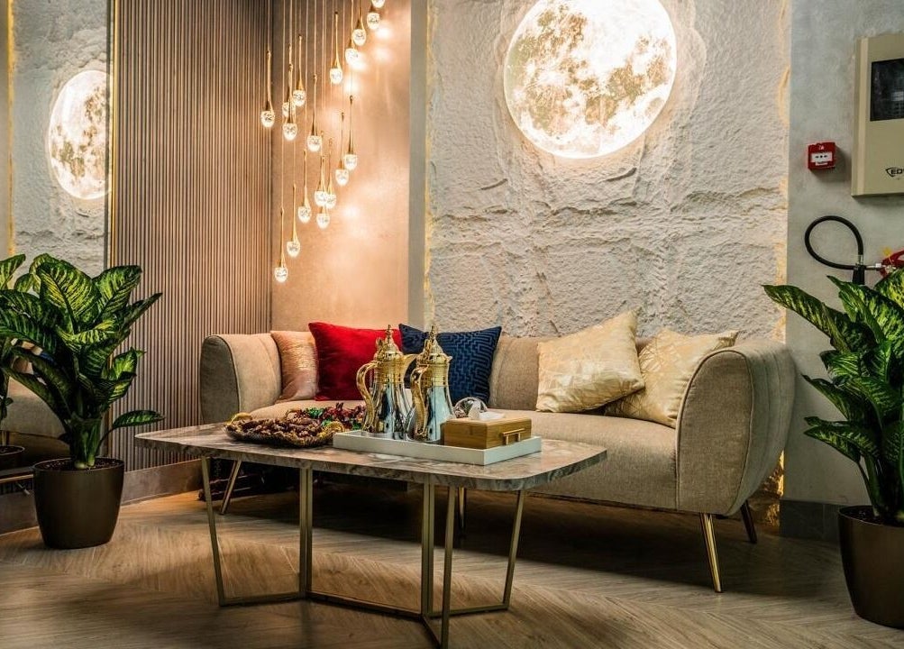 Chic lounge area at Peaky Queen Beauty Salon, Dubai, AE with plush seating and ambient lighting.