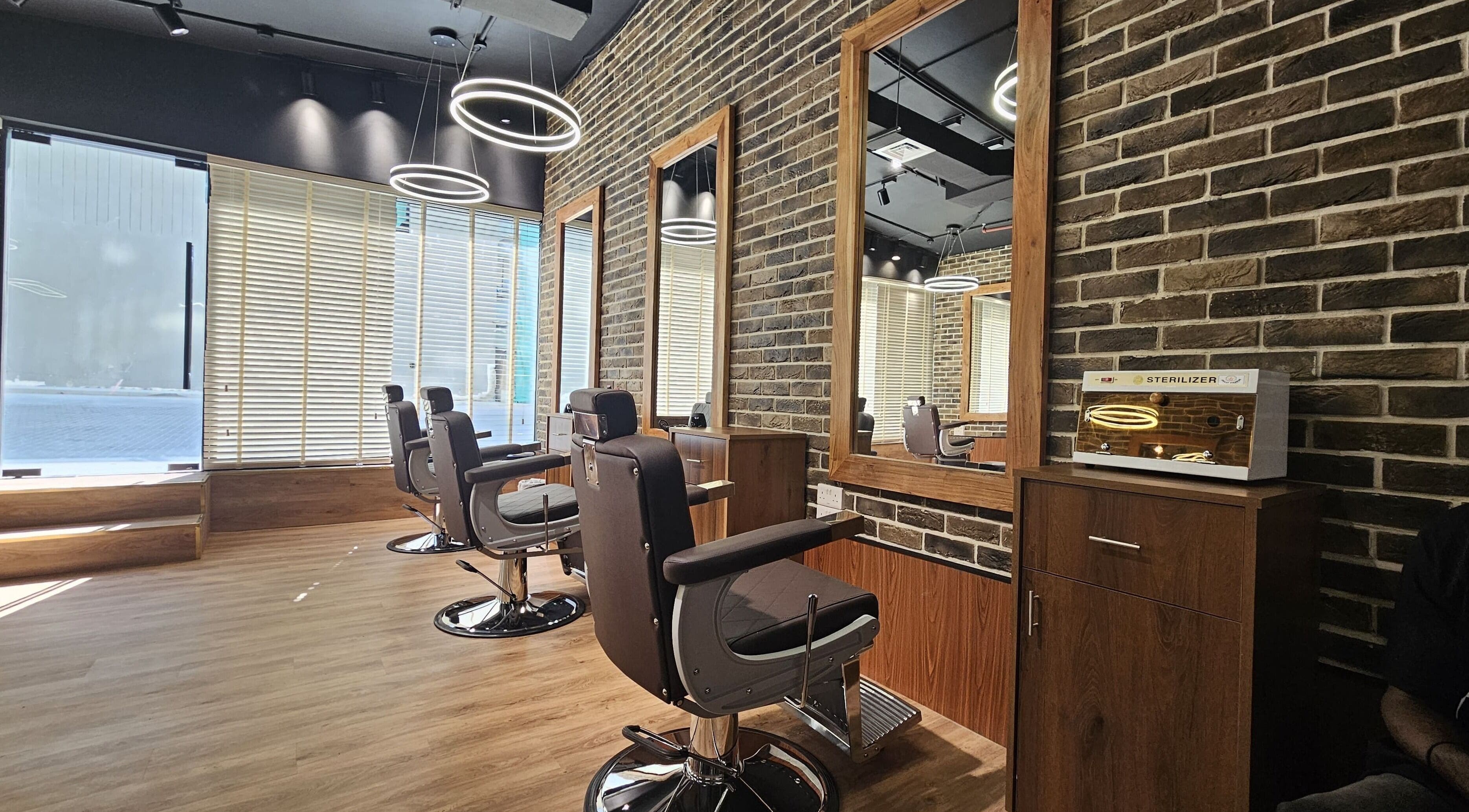 Modern barber chairs at Peaky Blinders | Five JVC, Dubai, Dubai, AE offering stylish grooming ambiance.