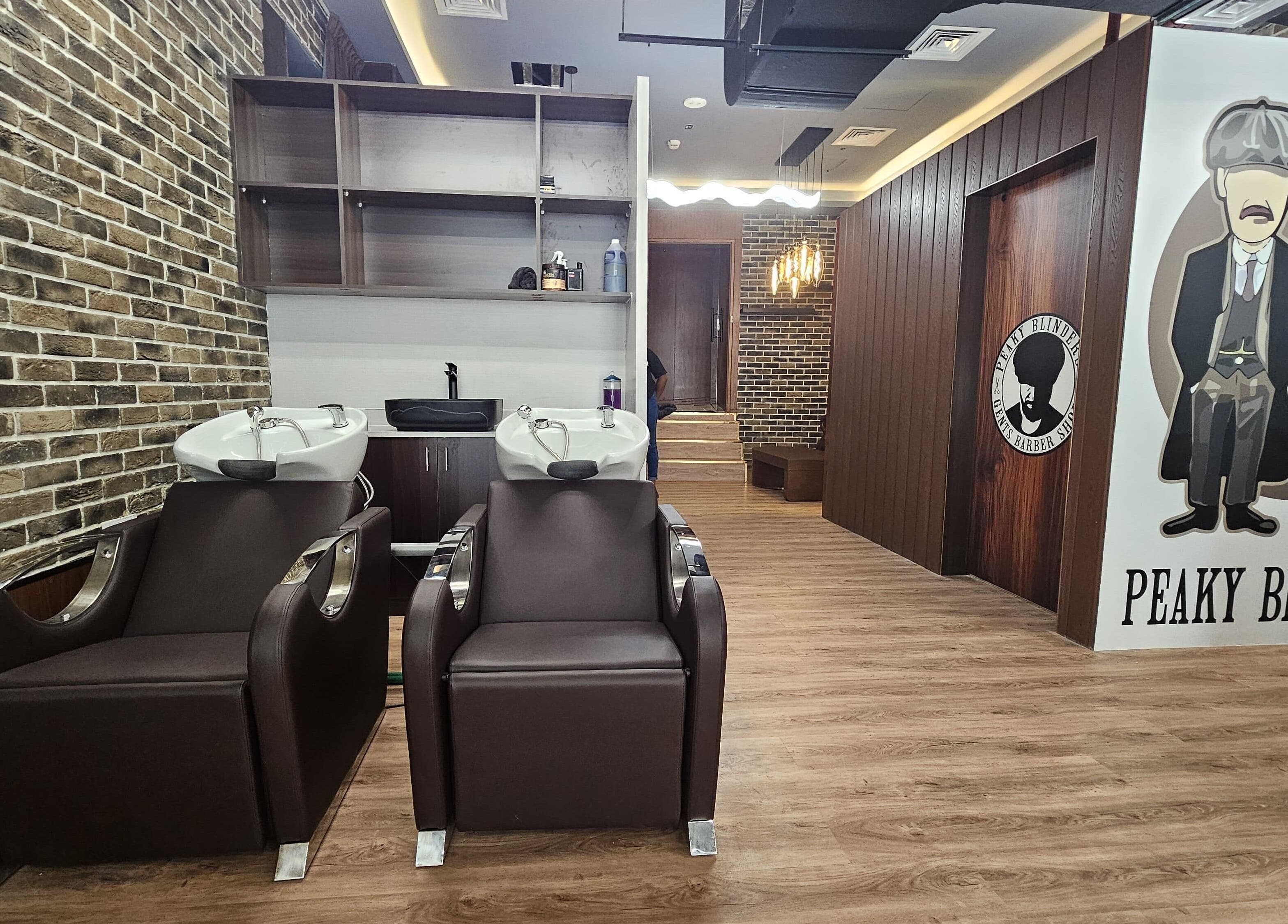 Interior of Peaky Blinders | Five JVC salon in Dubai, Dubai, AE featuring stylish hair washing stations.