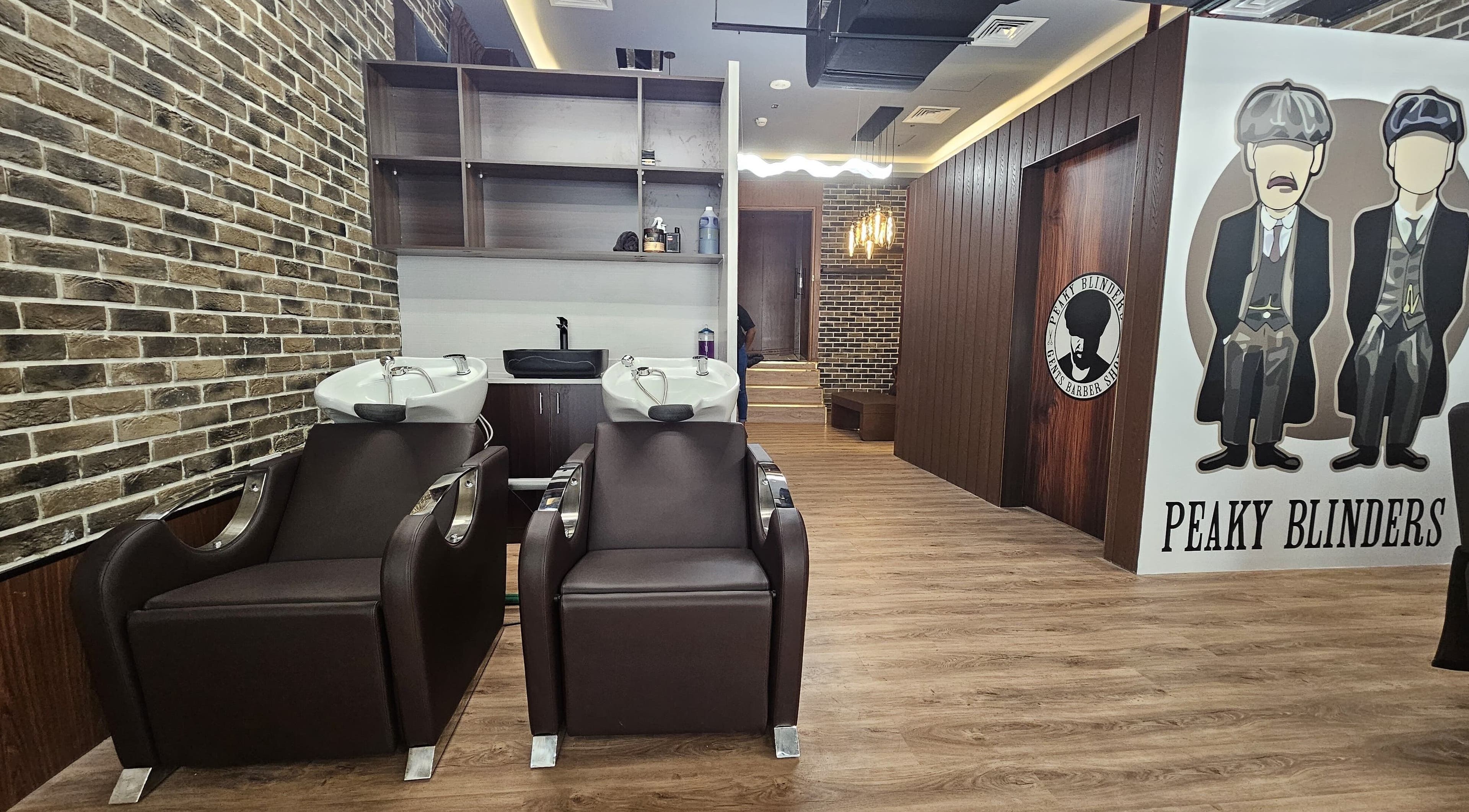 Interior of Peaky Blinders | Five JVC salon in Dubai, Dubai, AE featuring stylish hair washing stations.