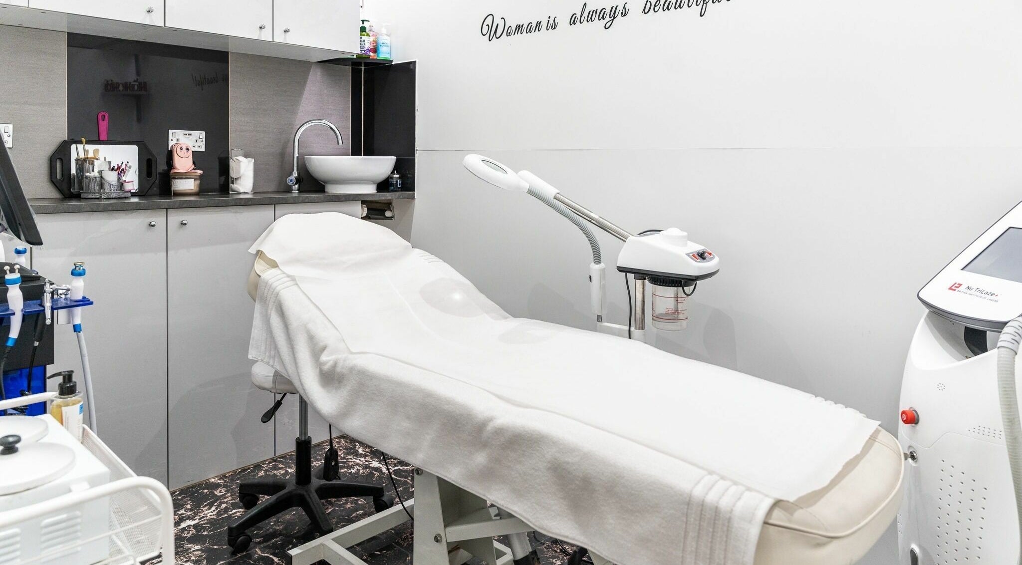 Treatment room at Rich Hair, Ilford, England, GB with spa bed and modern equipment for beauty services.