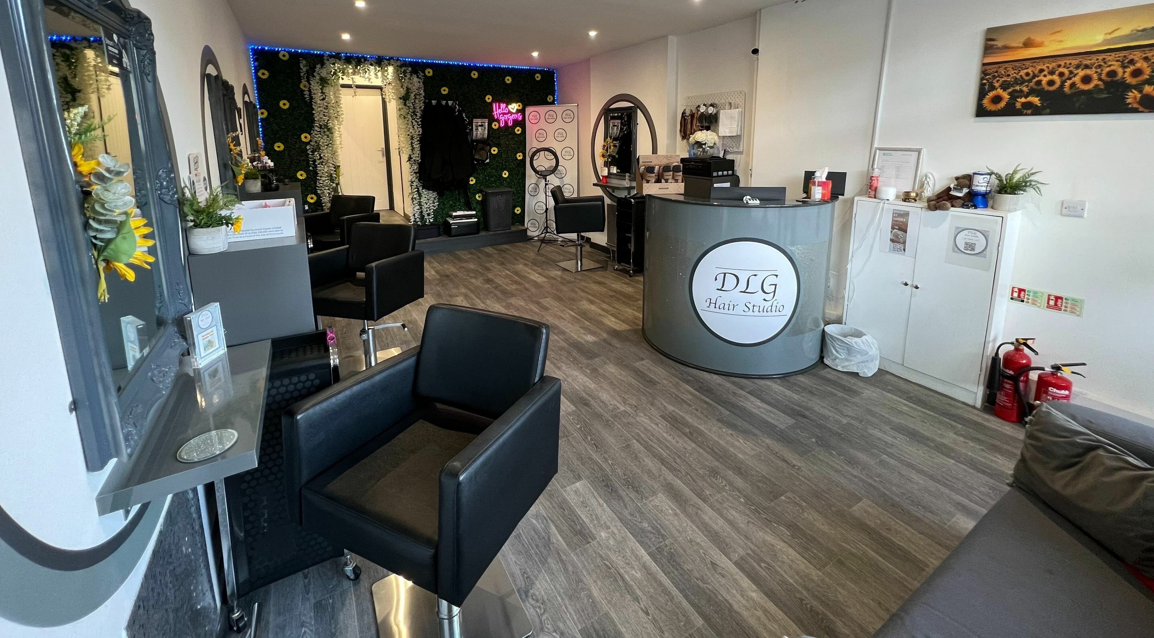 Interior of DLG Hair Studio with modern decor in Worthing, England, GB, showcasing sleek salon chairs and mirrors.