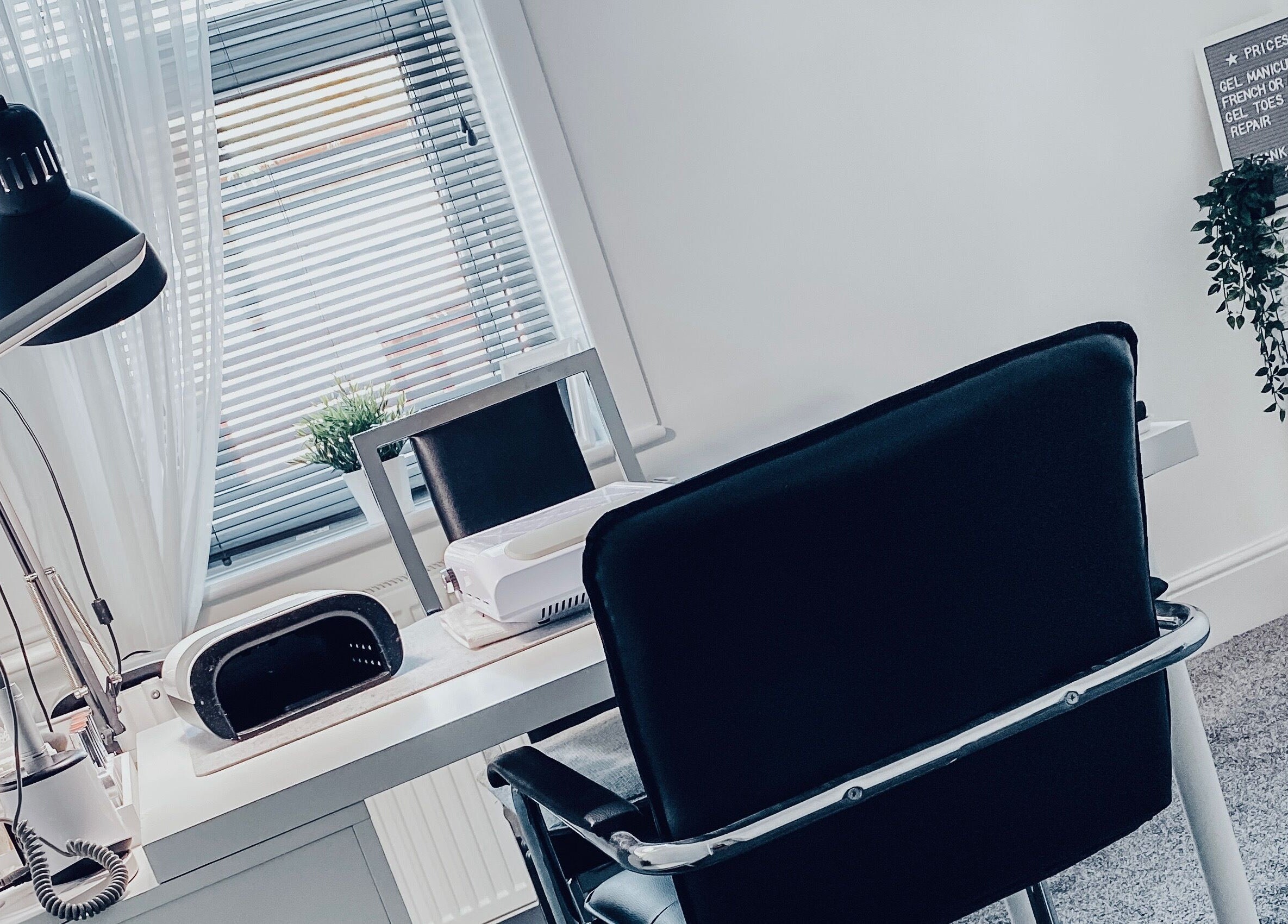 Modern nail studio at Truly Nails, Cadishead, England, GB with sleek furniture and desk lighting.