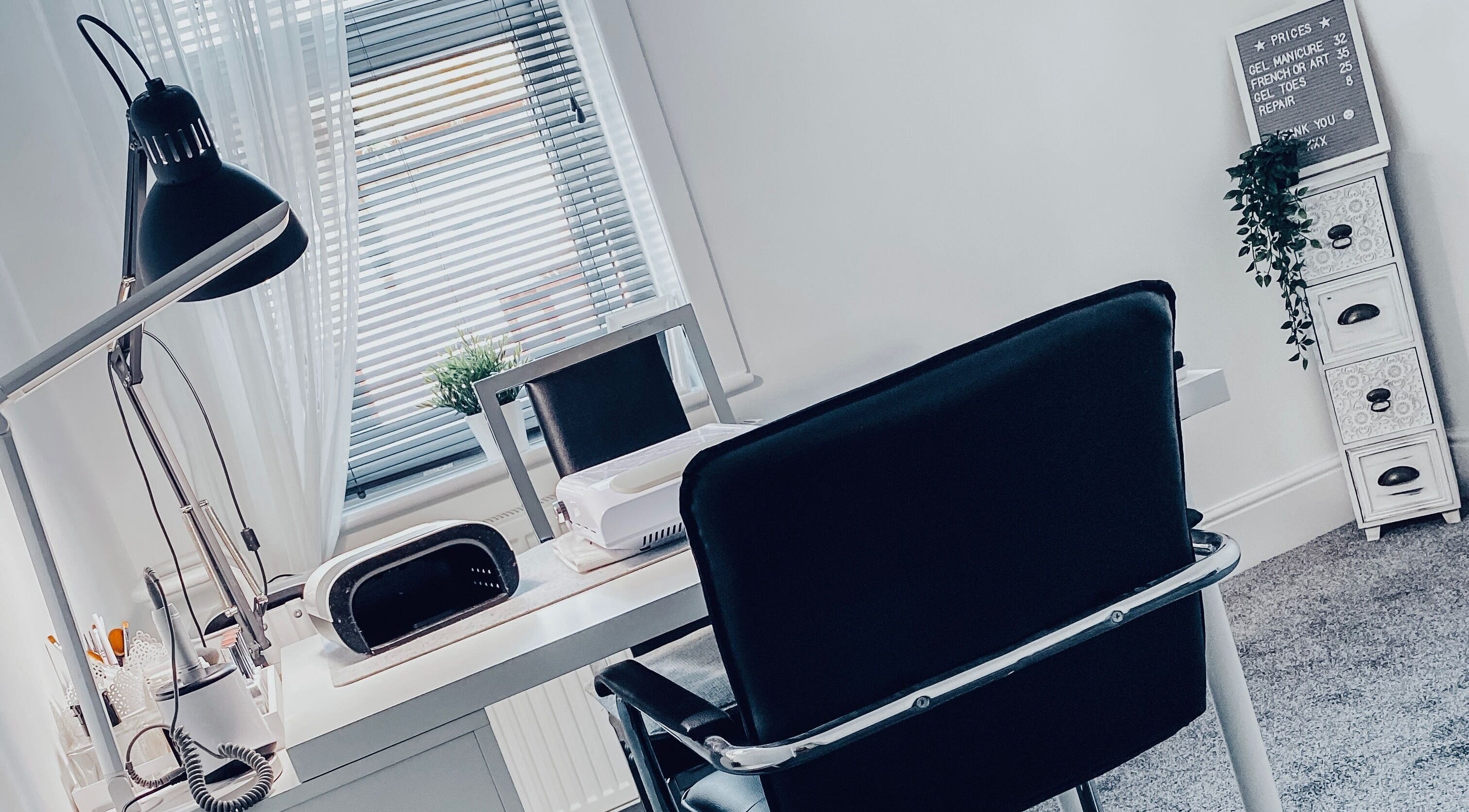 Modern nail studio at Truly Nails, Cadishead, England, GB with sleek furniture and desk lighting.