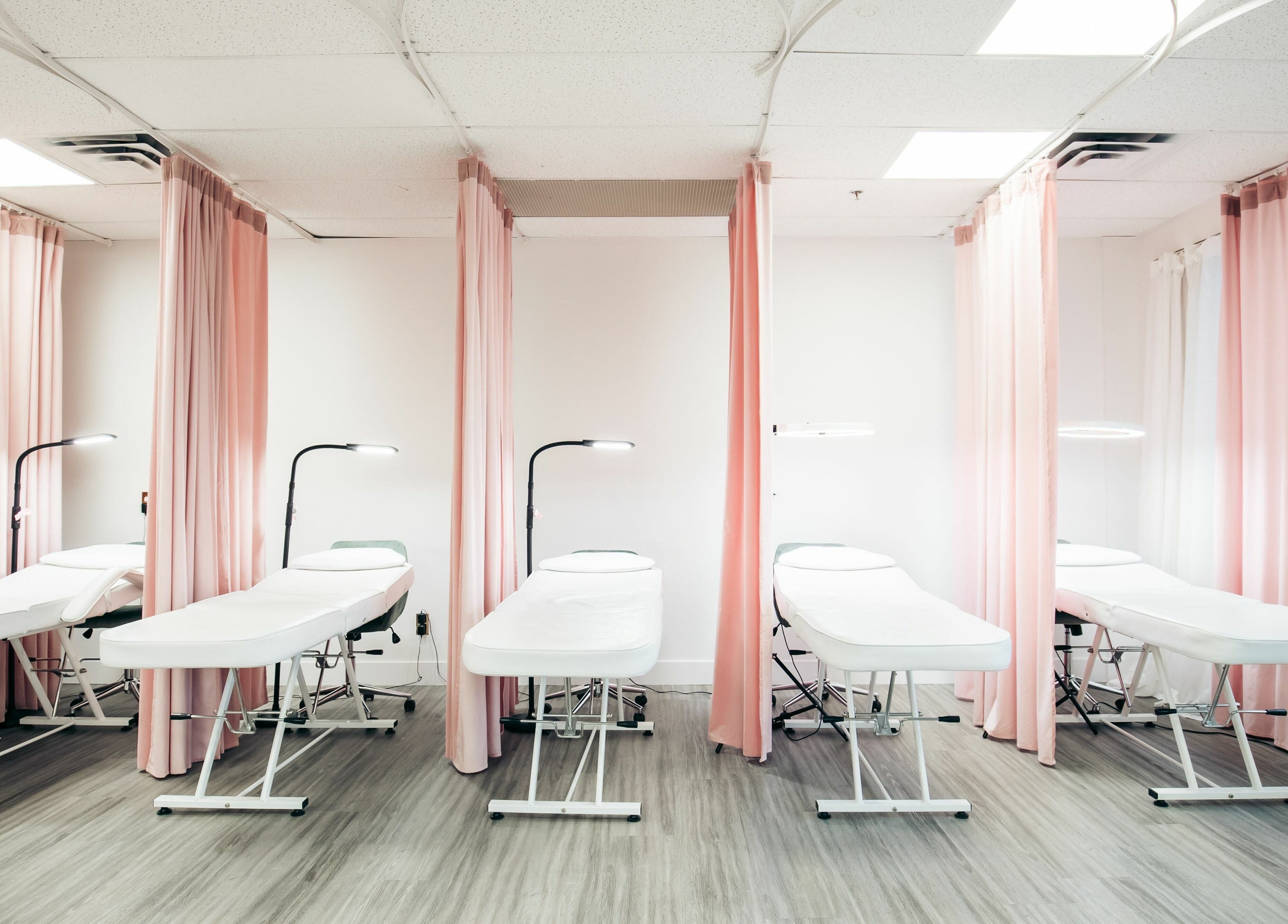 Chic treatment beds at The Hive Beauty in Langley Township, British Columbia, CA create a relaxing atmosphere.