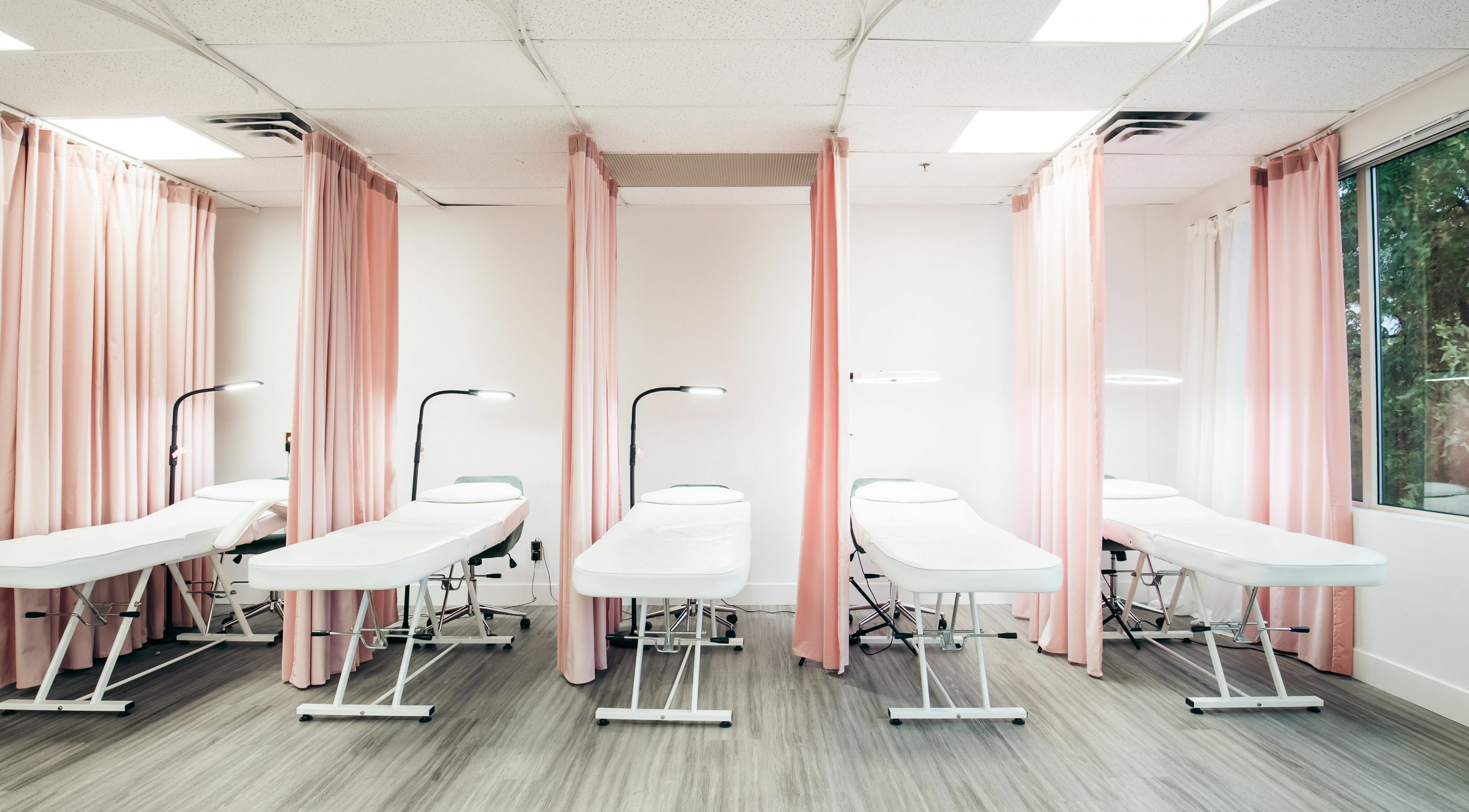 Chic treatment beds at The Hive Beauty in Langley Township, British Columbia, CA create a relaxing atmosphere.