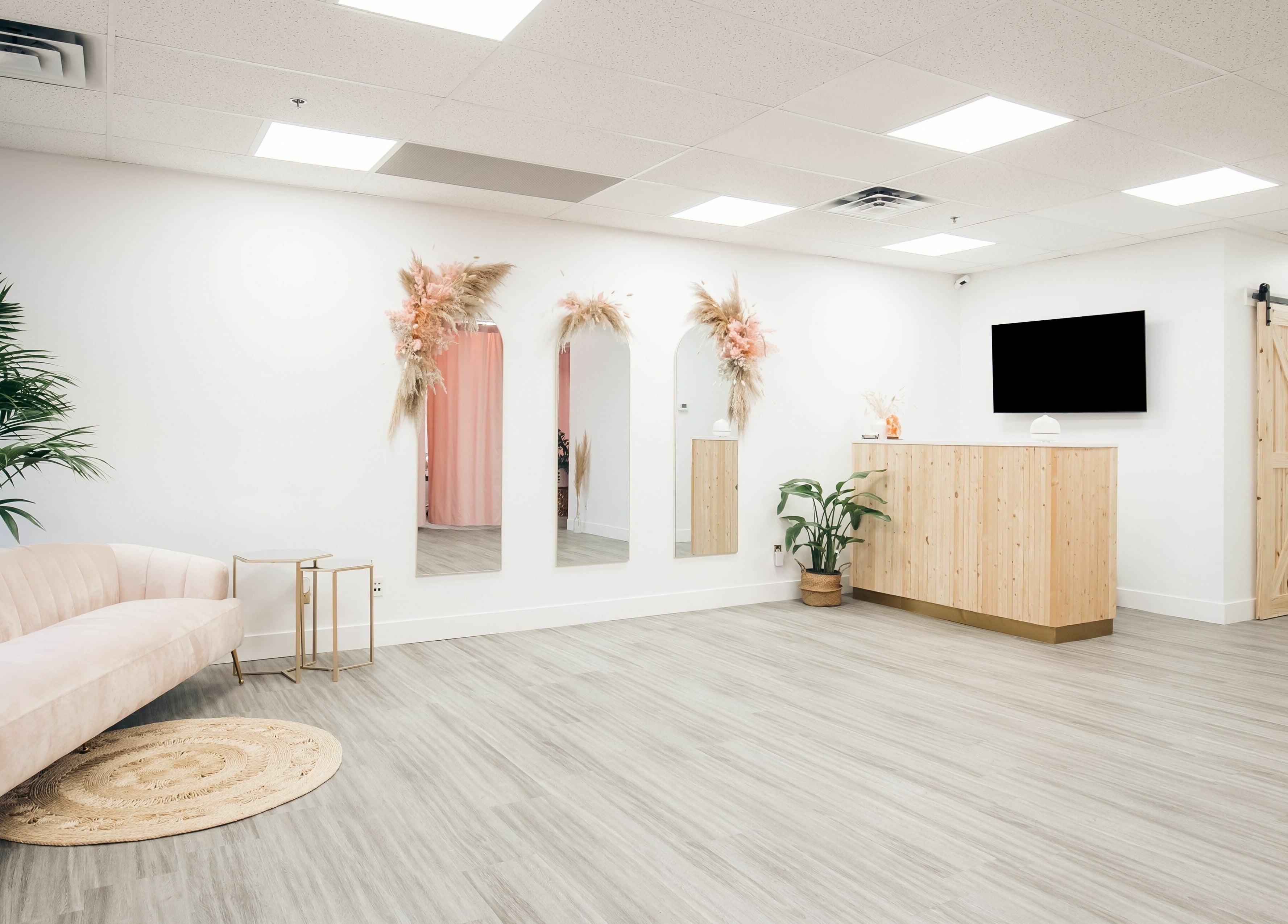 Chic waiting area at The Hive Beauty in Langley Township, British Columbia, CA with modern decor and plush seating.