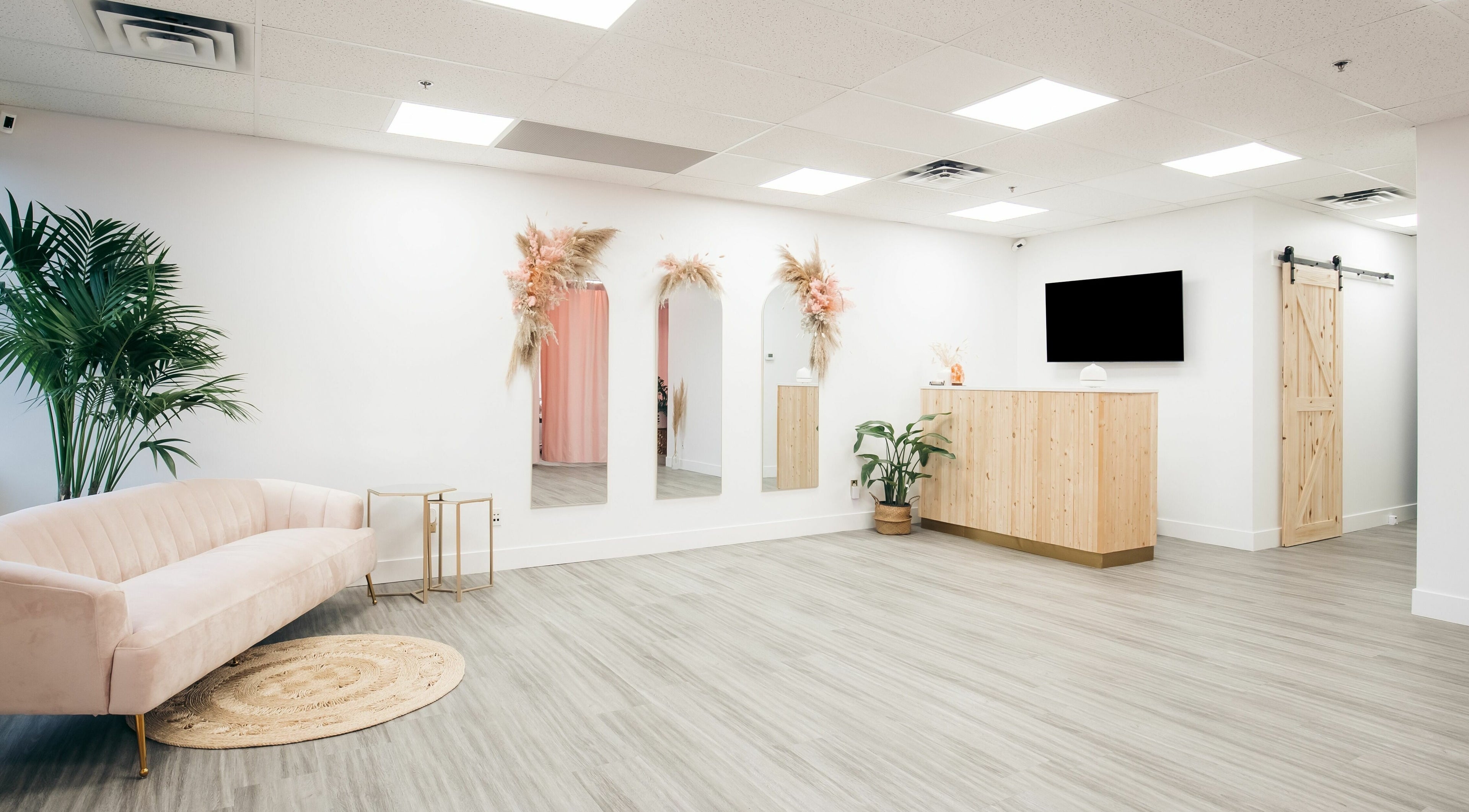 Chic waiting area at The Hive Beauty in Langley Township, British Columbia, CA with modern decor and plush seating.