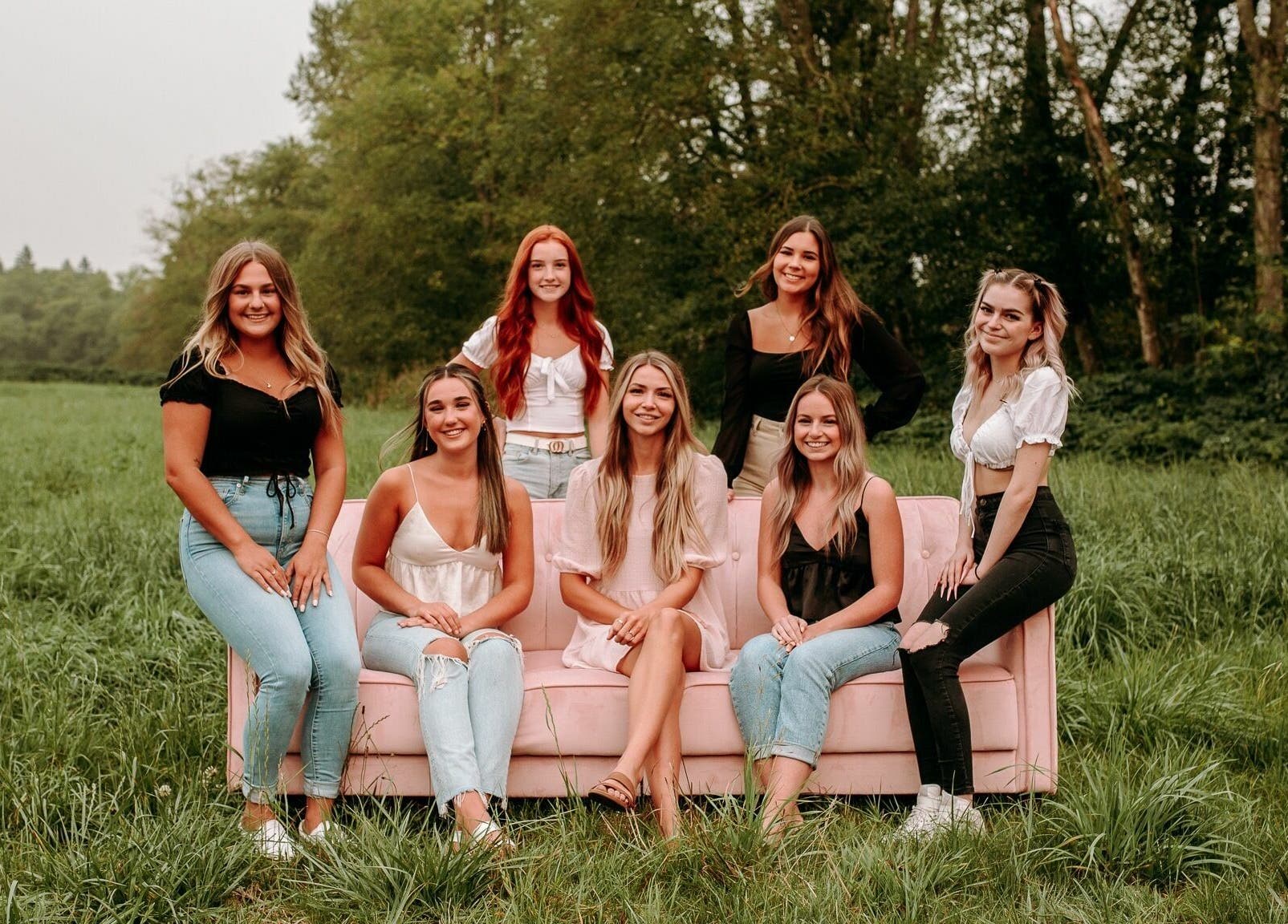 Team of women from The Hive Beauty smiling in a lush field, Langley Township, British Columbia, CA.
