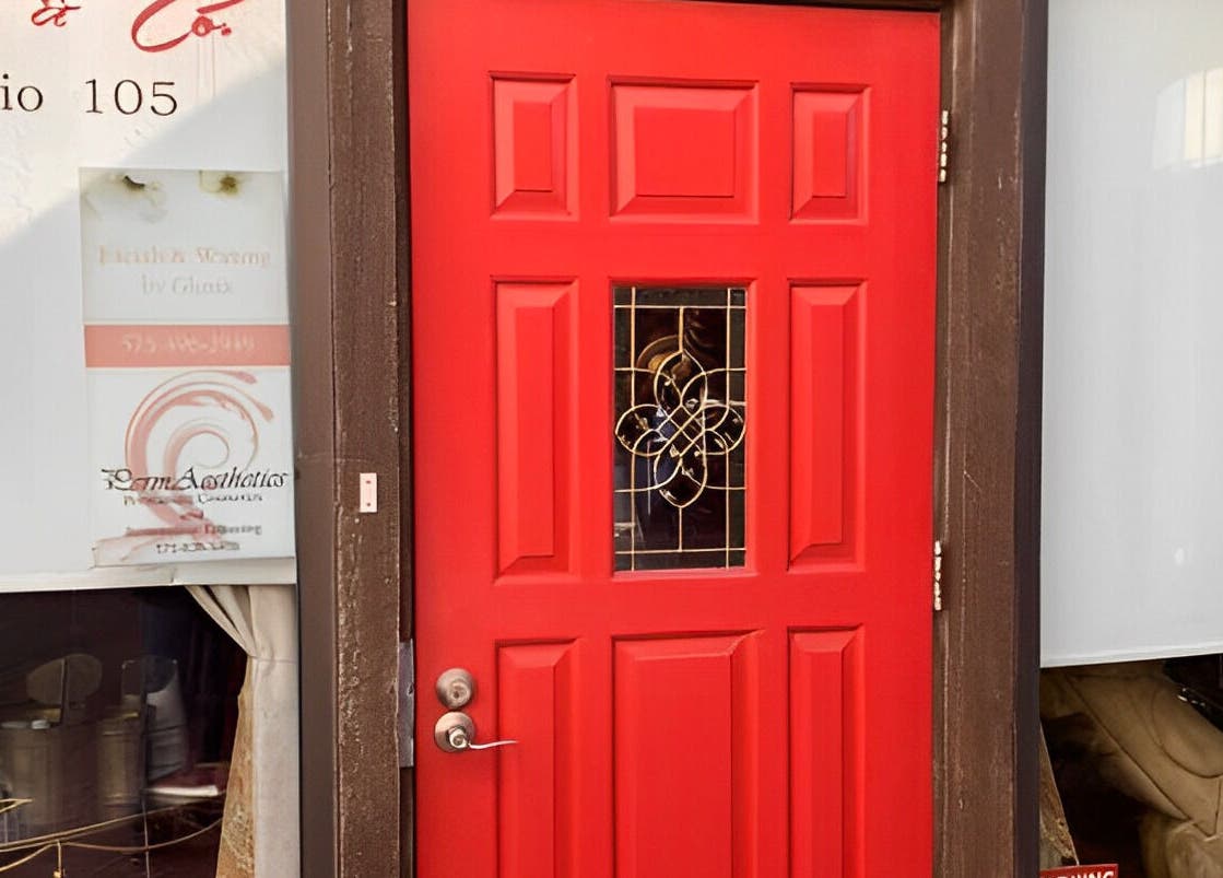 Bright red door of Amanda Zielkle LMT 7904 in Las Cruces, New Mexico, US, showcasing elegant design.