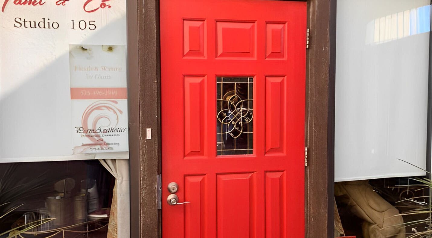 Bright red door of Amanda Zielkle LMT 7904 in Las Cruces, New Mexico, US, showcasing elegant design.