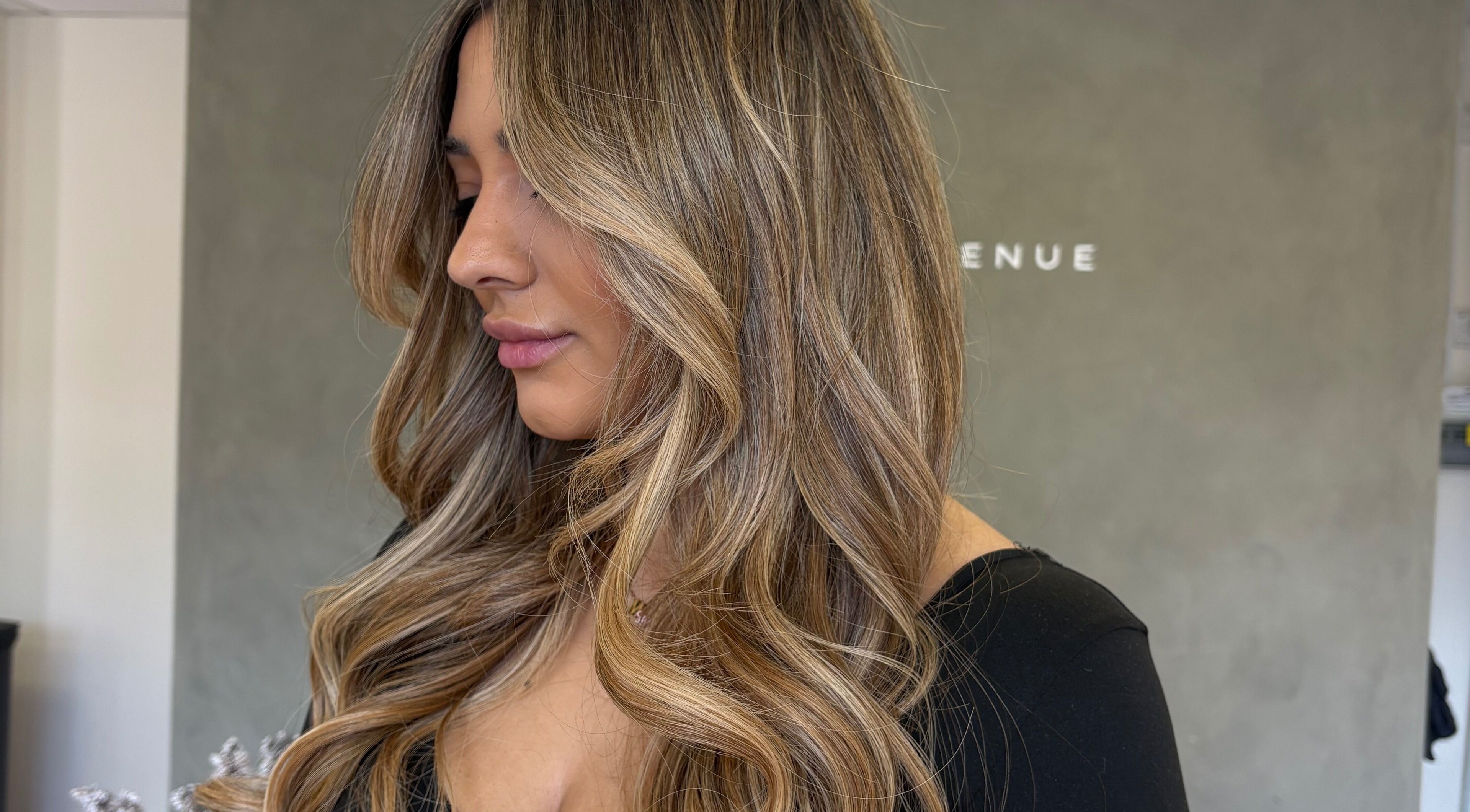 Side view of luxurious blonde waves styled at Seventh West Avenue, Birmingham, England, GB.