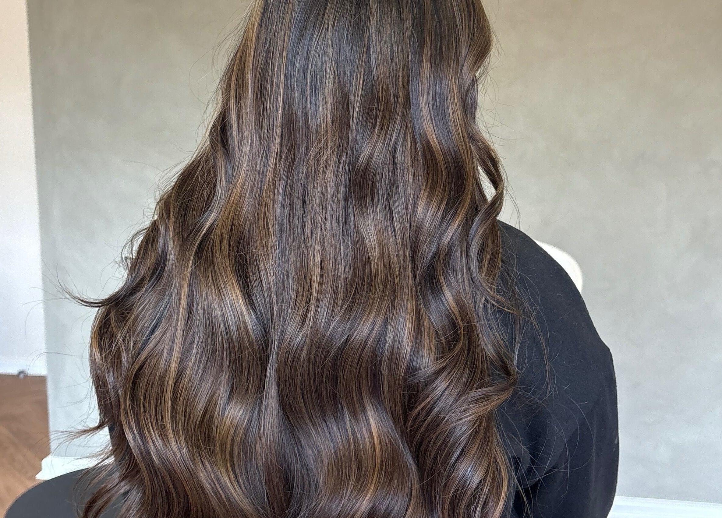 Luxurious wavy brown hair styled at Seventh West Avenue, Birmingham, England, GB.