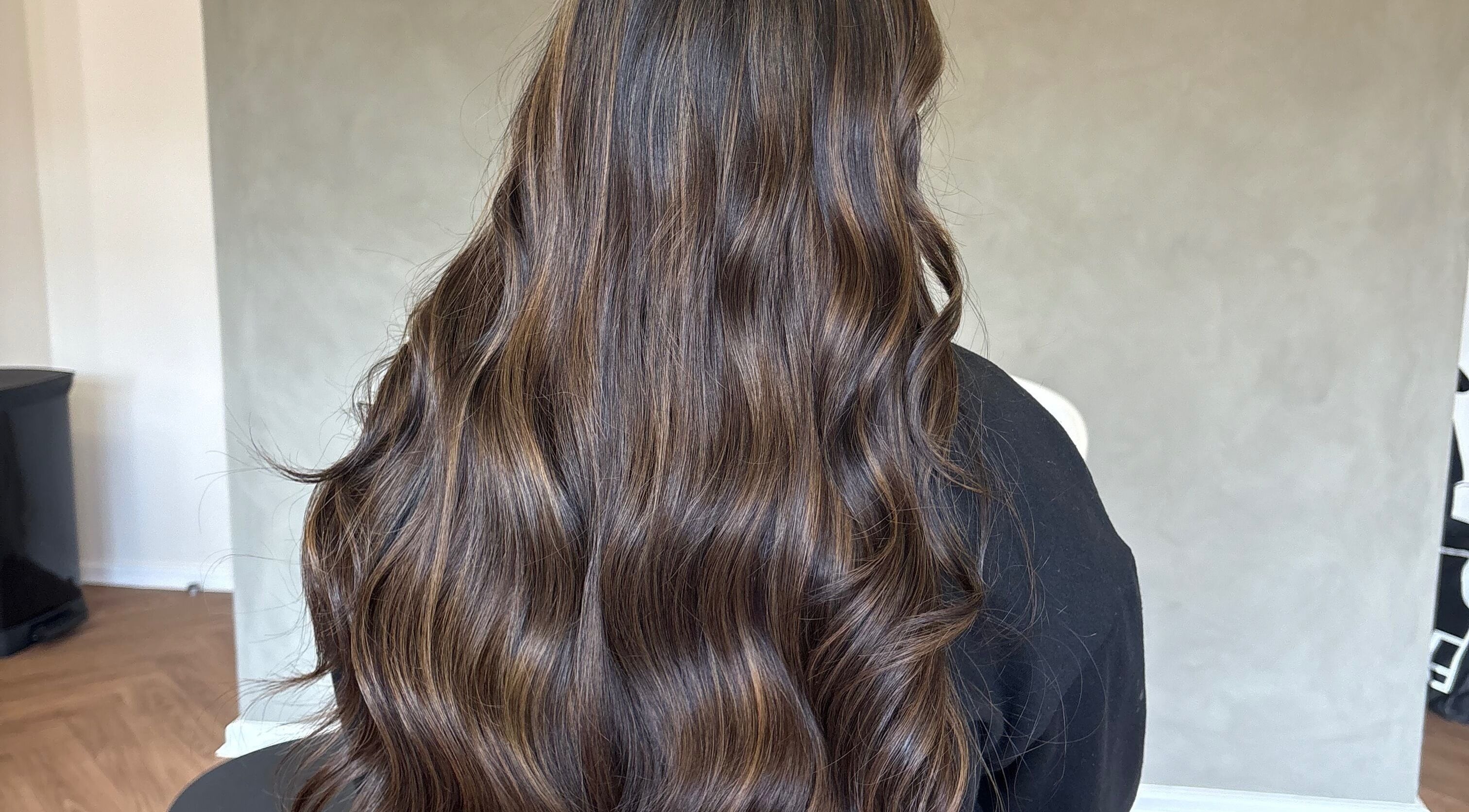 Luxurious wavy brown hair styled at Seventh West Avenue, Birmingham, England, GB.