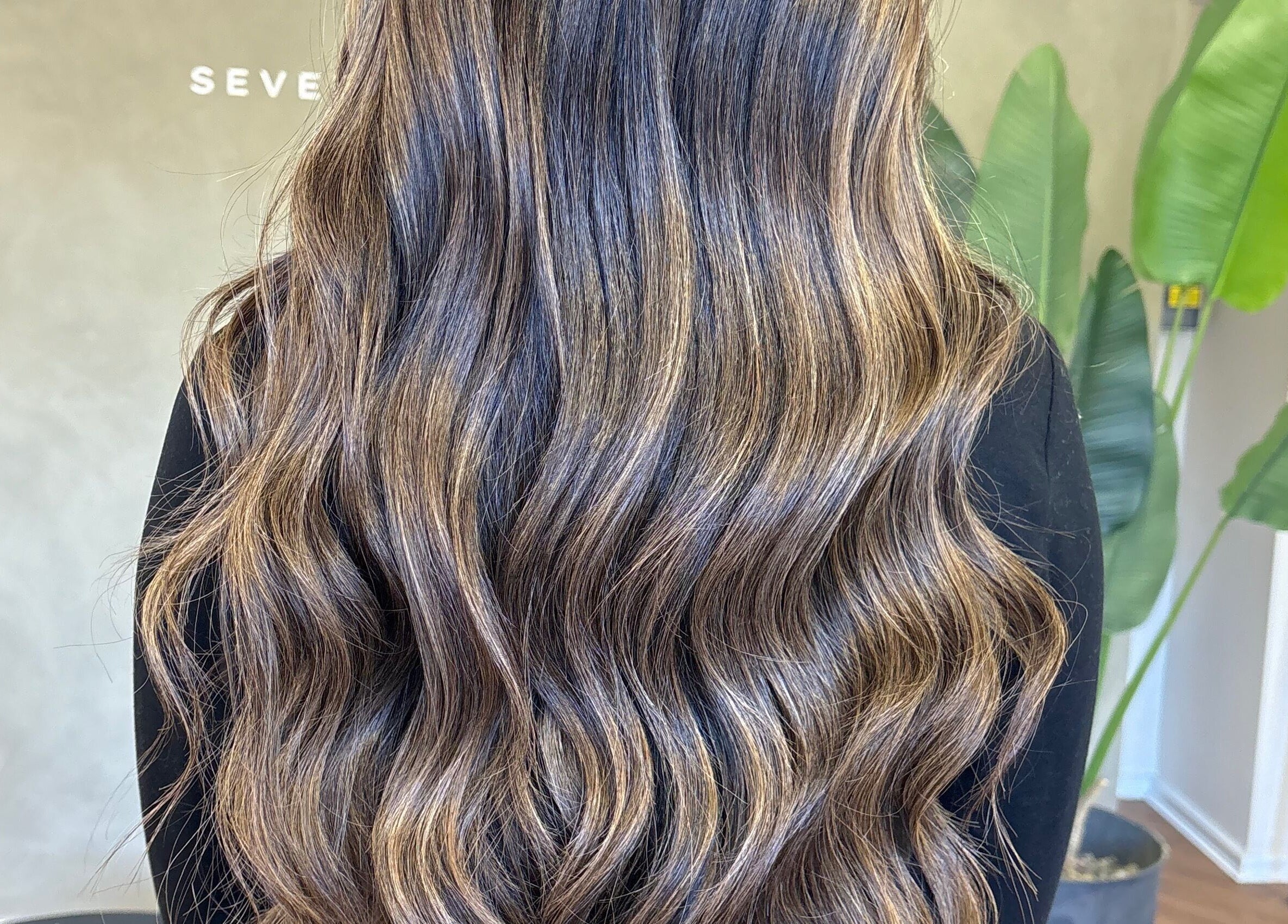 Rich wavy hair styled beautifully at Seventh West Avenue, Birmingham, England, GB.