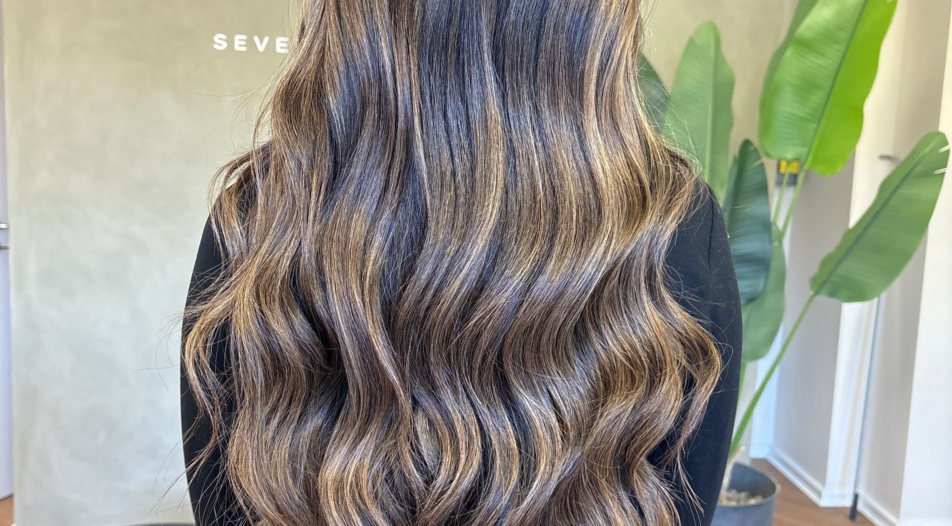 Rich wavy hair styled beautifully at Seventh West Avenue, Birmingham, England, GB.