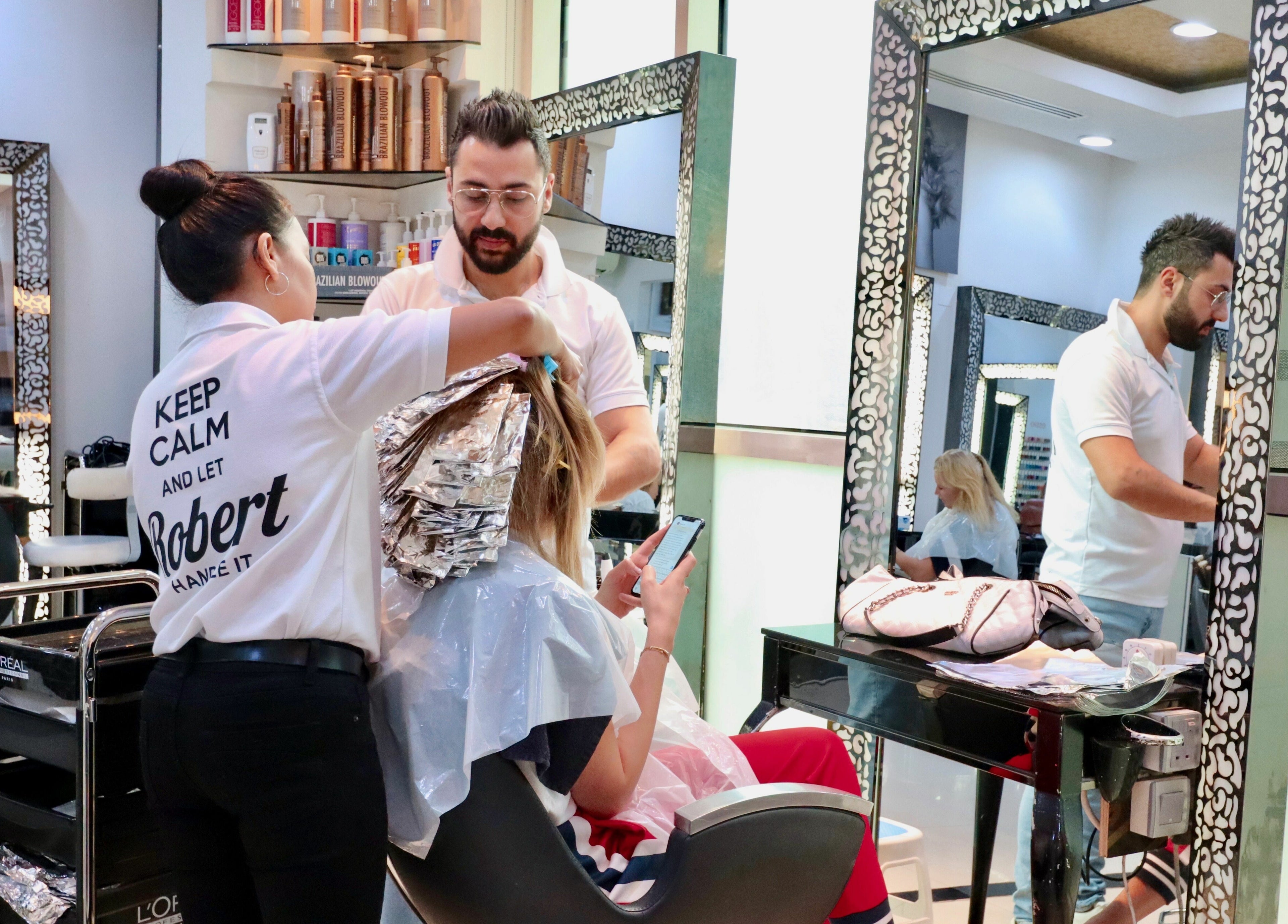 Client receiving a professional hair treatment at Robert Alexander Salon, Dubai, Dubai, AE.