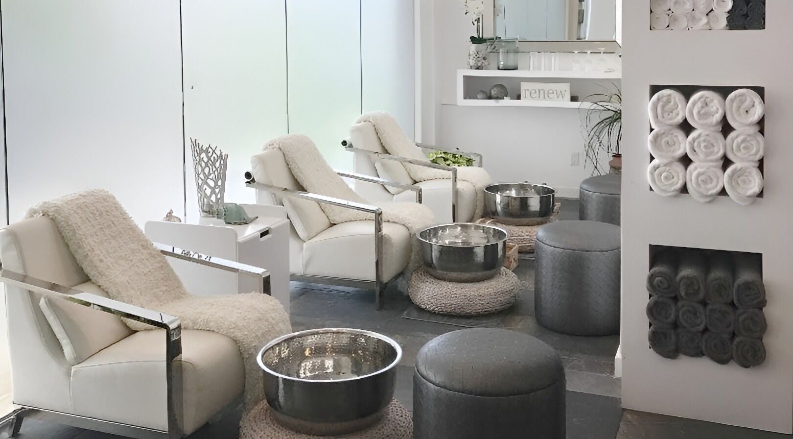 Relaxing pedicure area at Atera Boutique Spa, Holetown, Saint James, BB featuring plush chairs and foot basins.