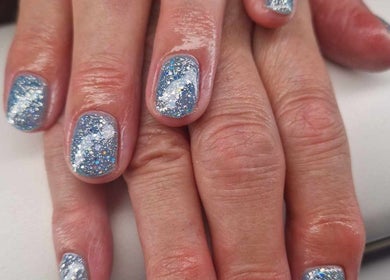 Sparkling blue glitter nails at Dragonfly Beauty in South Hiendley, England, GB, highlighting elegance.