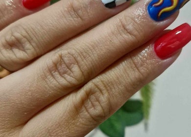 Vibrant nail art featuring red, blue, and flames at Dragonfly Beauty, South Hiendley, England, GB.
