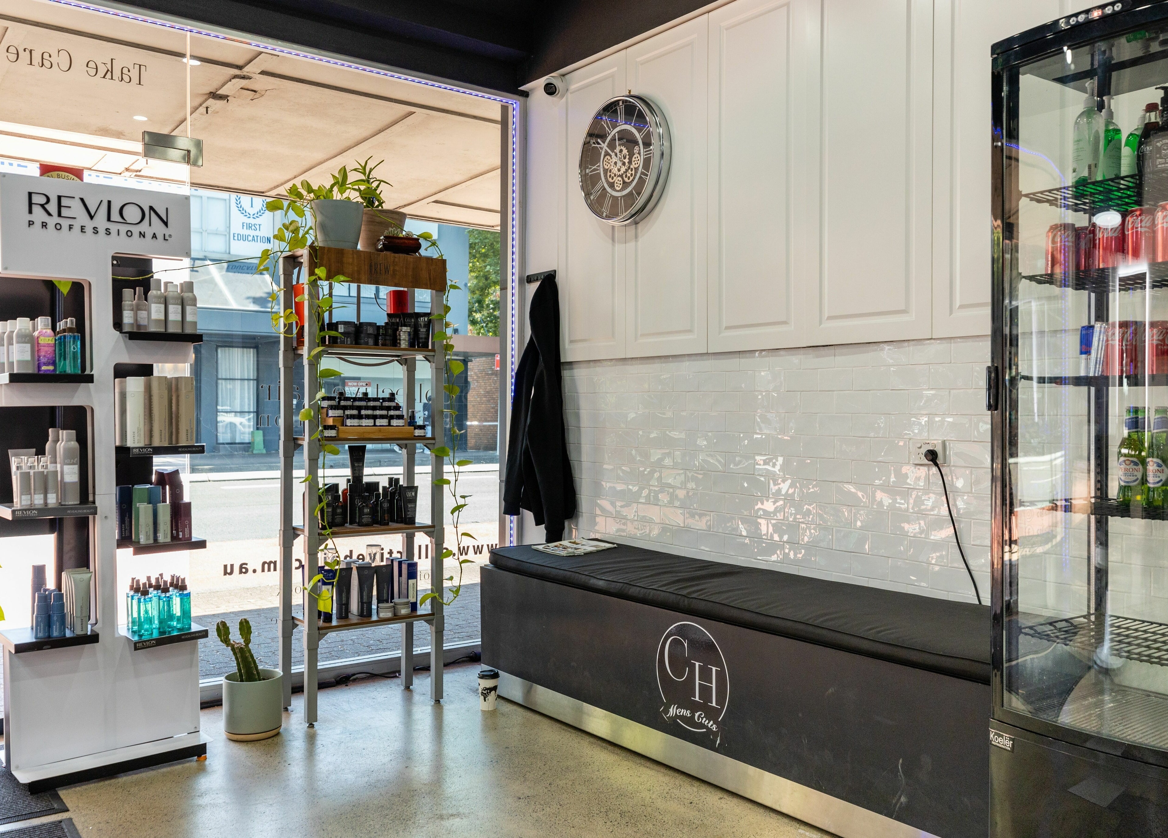 View of Collective Hair's entry with product displays in Mascot, Pensioners 25% Off, AU.