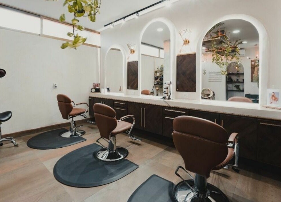 Spacious salon at Salon 144, Cabo San Lucas, Baja California Sur, MX, featuring chic styling chairs and modern decor.