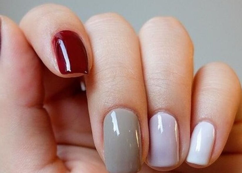 Elegant nail art at Niche Salon Bangkok, Krung Thep Maha Nakhon, TH showcasing multicolored polished nails.