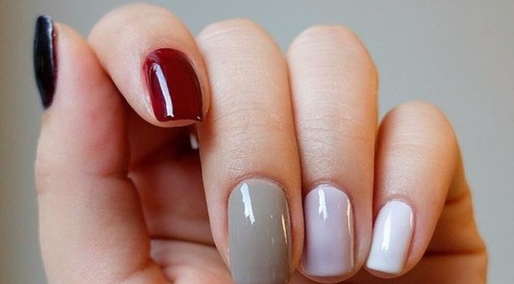 Elegant nail art at Niche Salon Bangkok, Krung Thep Maha Nakhon, TH showcasing multicolored polished nails.