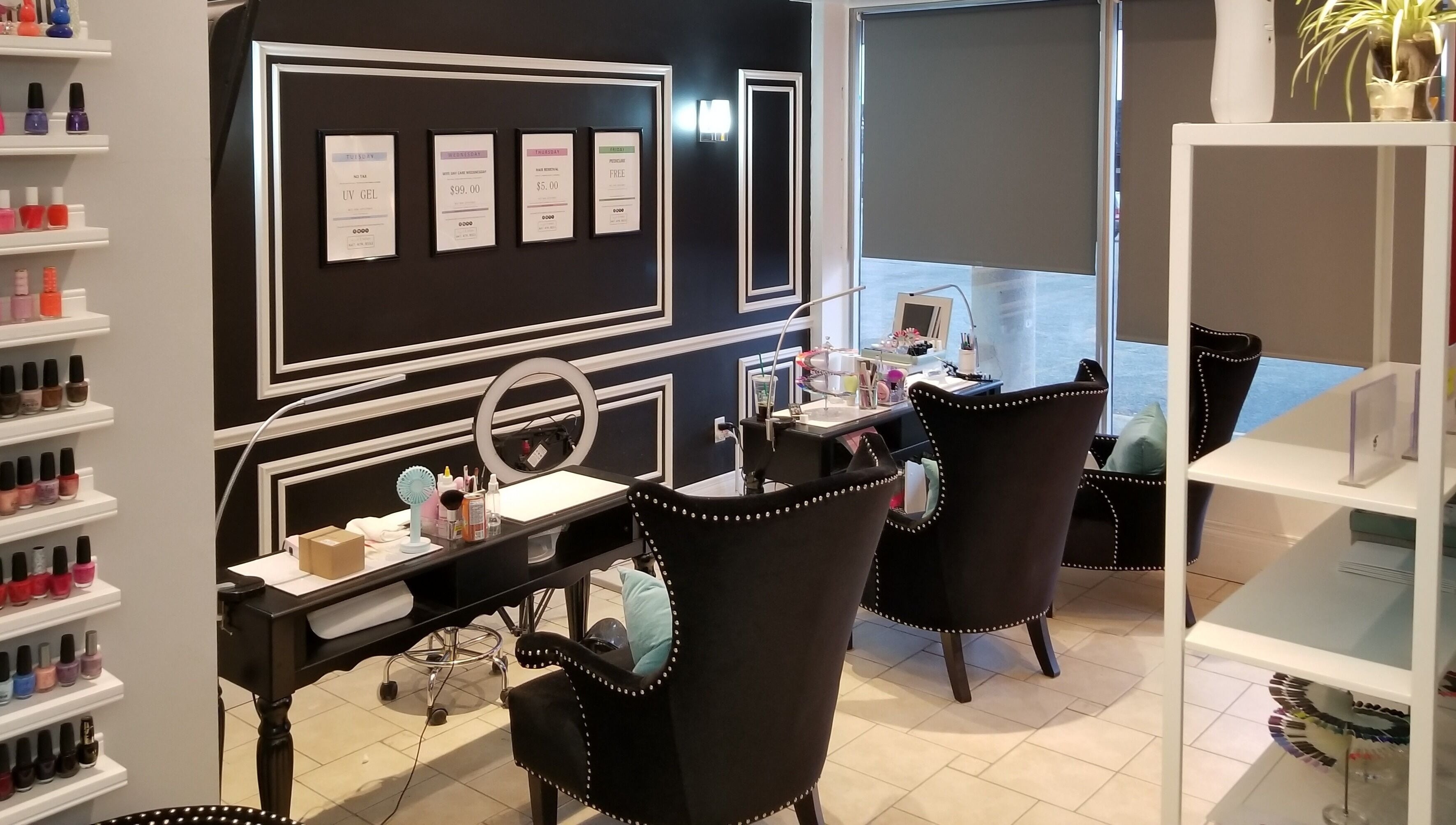 Chic interior of Dazzle Nailspa in Toronto, Ontario, CA with sleek black chairs and nail polish display.