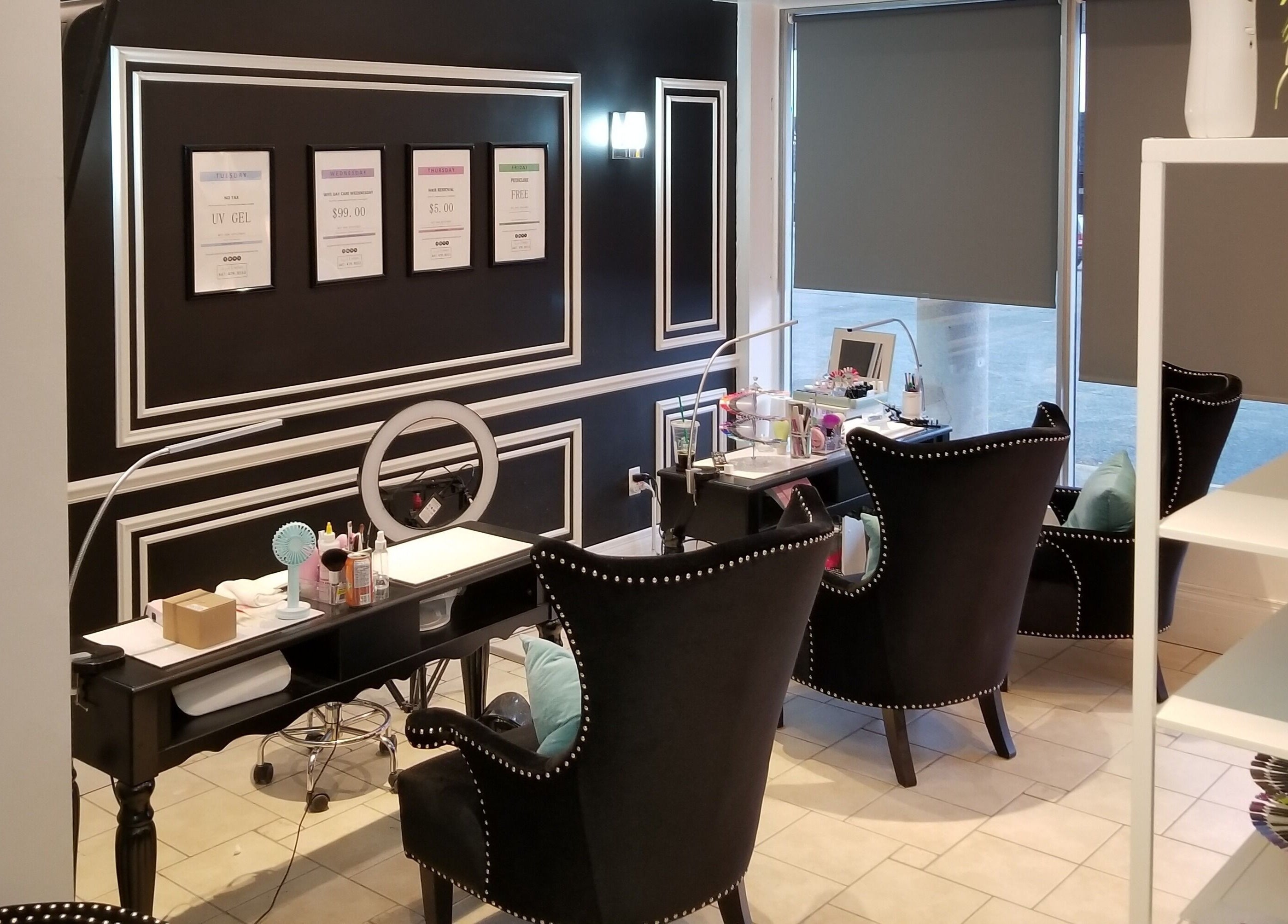 Chic interior of Dazzle Nailspa in Toronto, Ontario, CA with sleek black chairs and nail polish display.
