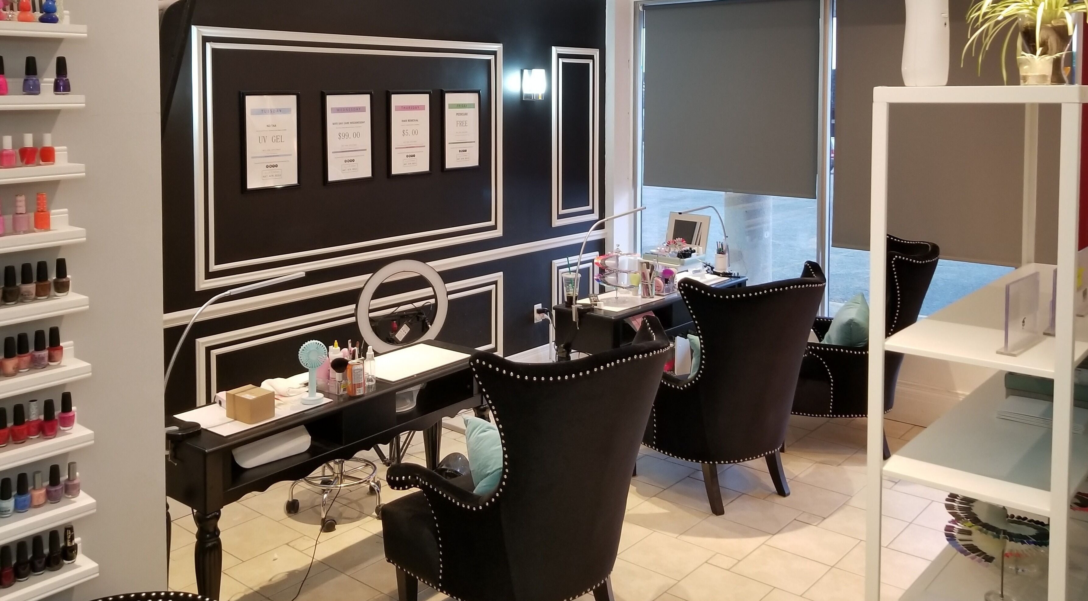 Chic interior of Dazzle Nailspa in Toronto, Ontario, CA with sleek black chairs and nail polish display.