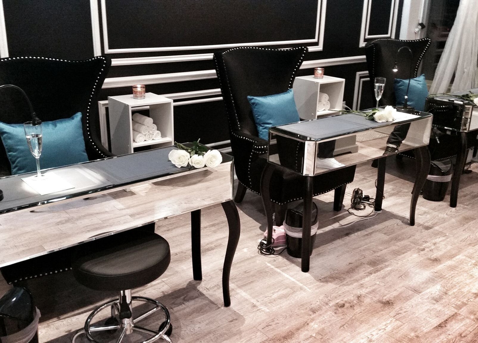 Luxurious manicure stations at Dazzle Nailspa in Toronto, Ontario, CA with chic seating and decor.