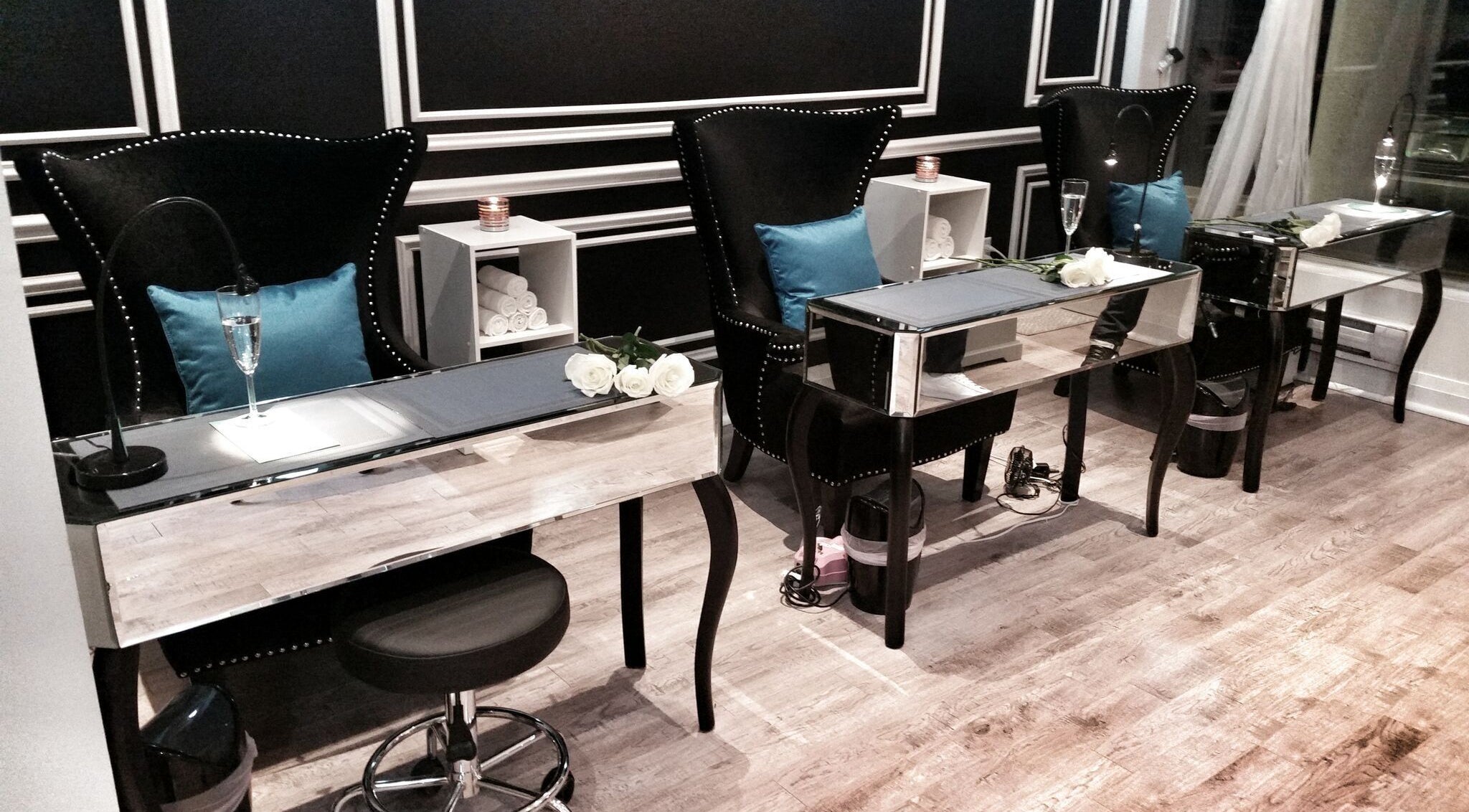 Luxurious manicure stations at Dazzle Nailspa in Toronto, Ontario, CA with chic seating and decor.