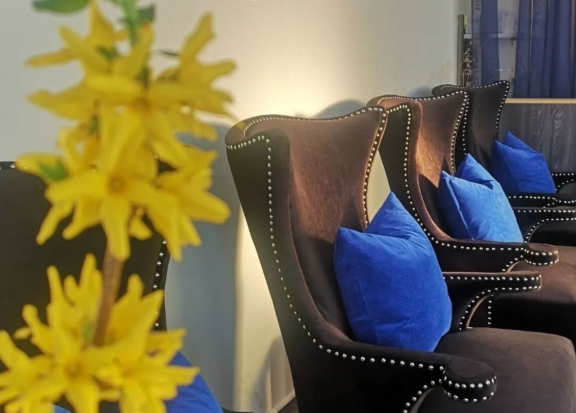 Elegant seating with blue cushions at Dazzle Nailspa, Toronto, Ontario, CA, creating a relaxing ambiance.