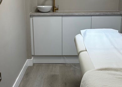 Relaxing treatment room at Sarah Gregory Beauty Clinic, Wilmslow, England, GB with massage table.