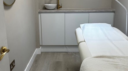 Relaxing treatment room at Sarah Gregory Beauty Clinic, Wilmslow, England, GB with massage table.