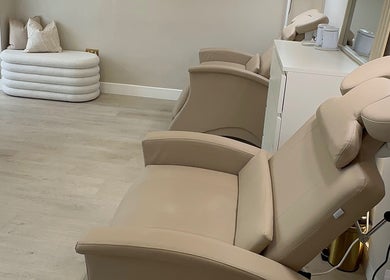 Elegant treatment room at Sarah Gregory Beauty Clinic, Wilmslow, England, GB with plush chairs and soothing decor.