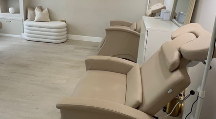 Elegant treatment room at Sarah Gregory Beauty Clinic, Wilmslow, England, GB with plush chairs and soothing decor.