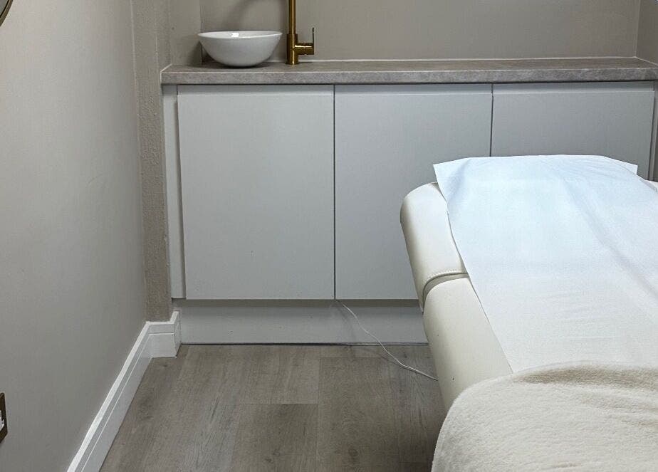 Serene treatment room at Sarah Gregory Beauty Clinic, Cheshire, England, GB with a cozy massage table.