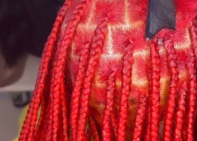Vibrant red braids styled at Studio 7 Hair and Braids, Sydney, New South Wales, AU, showcasing intricate design.