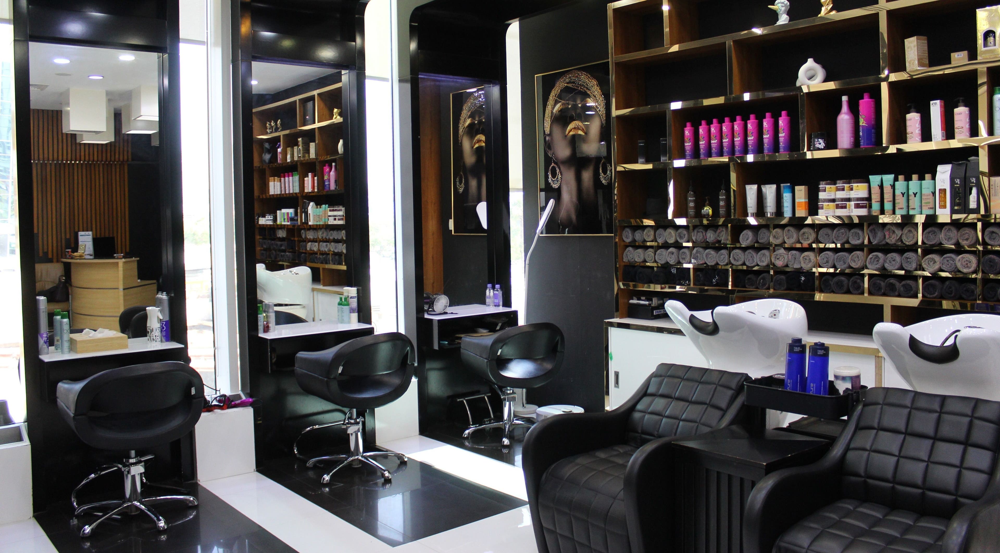 Chic salon interior at Aurora Ladies & Gents Beauty Center, Dubai, Dubai, AE showcasing stylish seating and products.