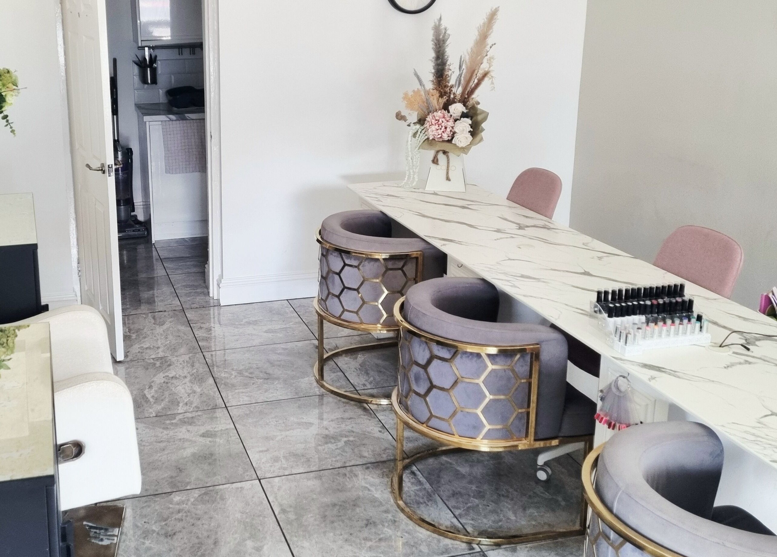 Chic nail table setup at Hiive Expert Nails in Swinton, England, GB, featuring plush seating and marble decor.